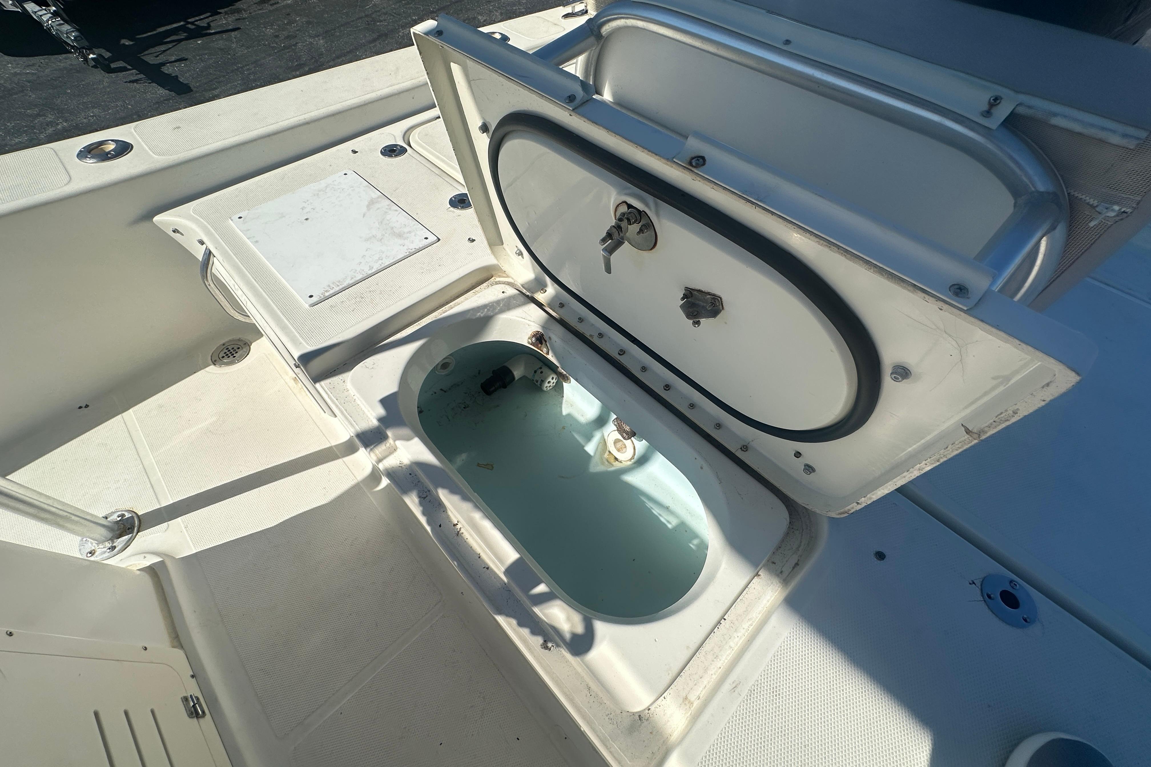 Open storage compartment on 2003 Hydra-Sports 19 Bay Bolt boat deck.