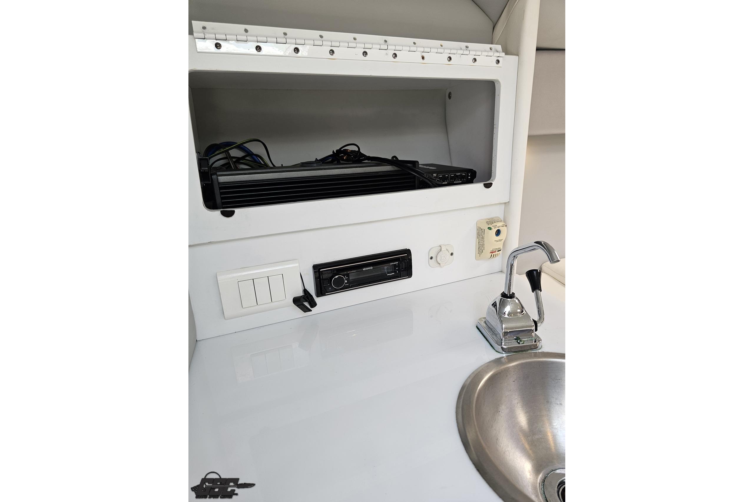 Interior of 2005 Formula 271 FASTech boat with sink, faucet, and control panel.