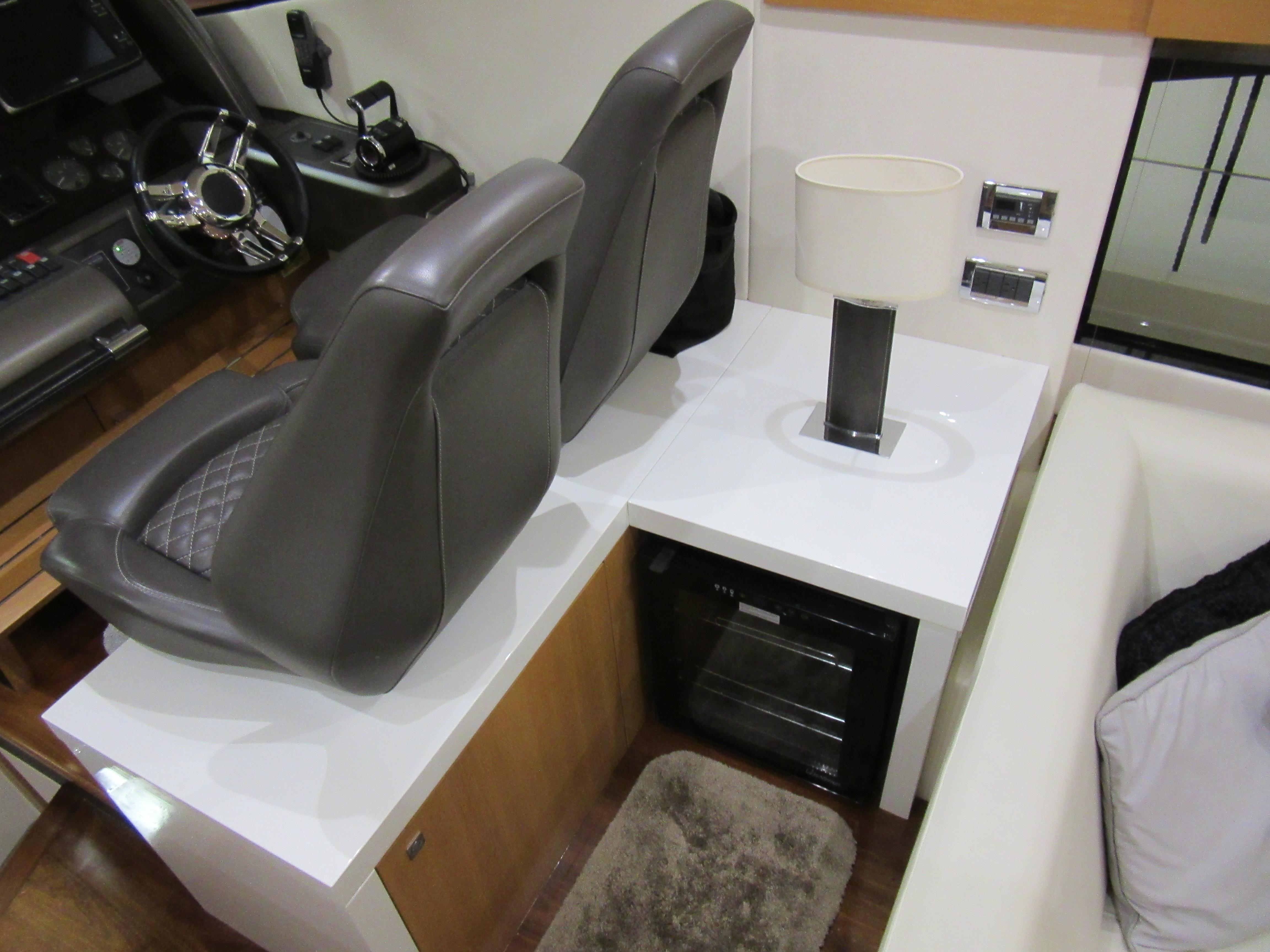 Interior of 2014 Sunseeker Manhattan 53 yacht with helm seats and modern decor.