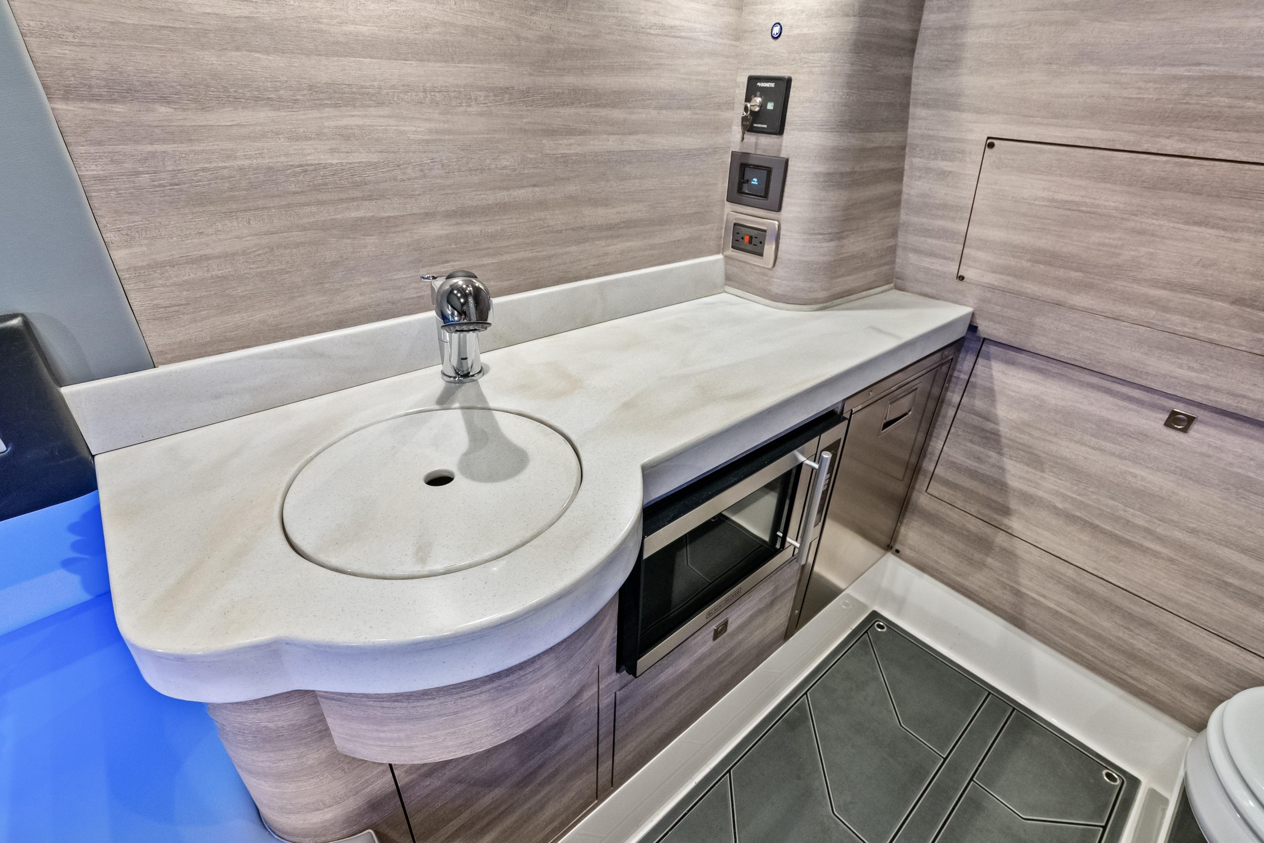Modern interior of 2027 Mystic Powerboats M4200 with sleek sink and cabinetry.