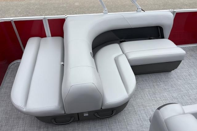2026 Sun Tracker Party Barge 18 DLX with sleek gray seating and red paneling.