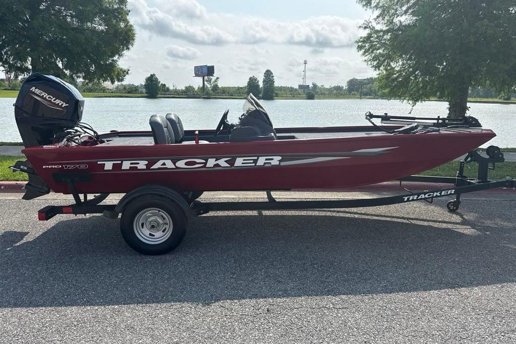 2026 Tracker Pro 170 boat on trailer by a lake, featuring a Mercury engine.