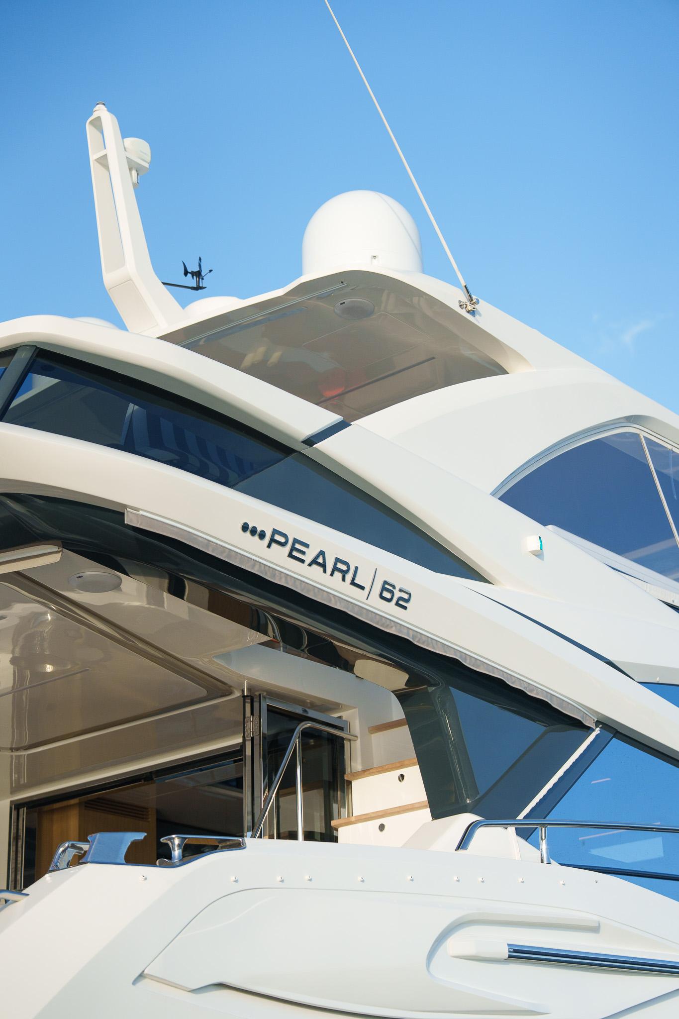 Luxury Pearl 62 yacht, 2023 model, sleek design against clear blue sky.