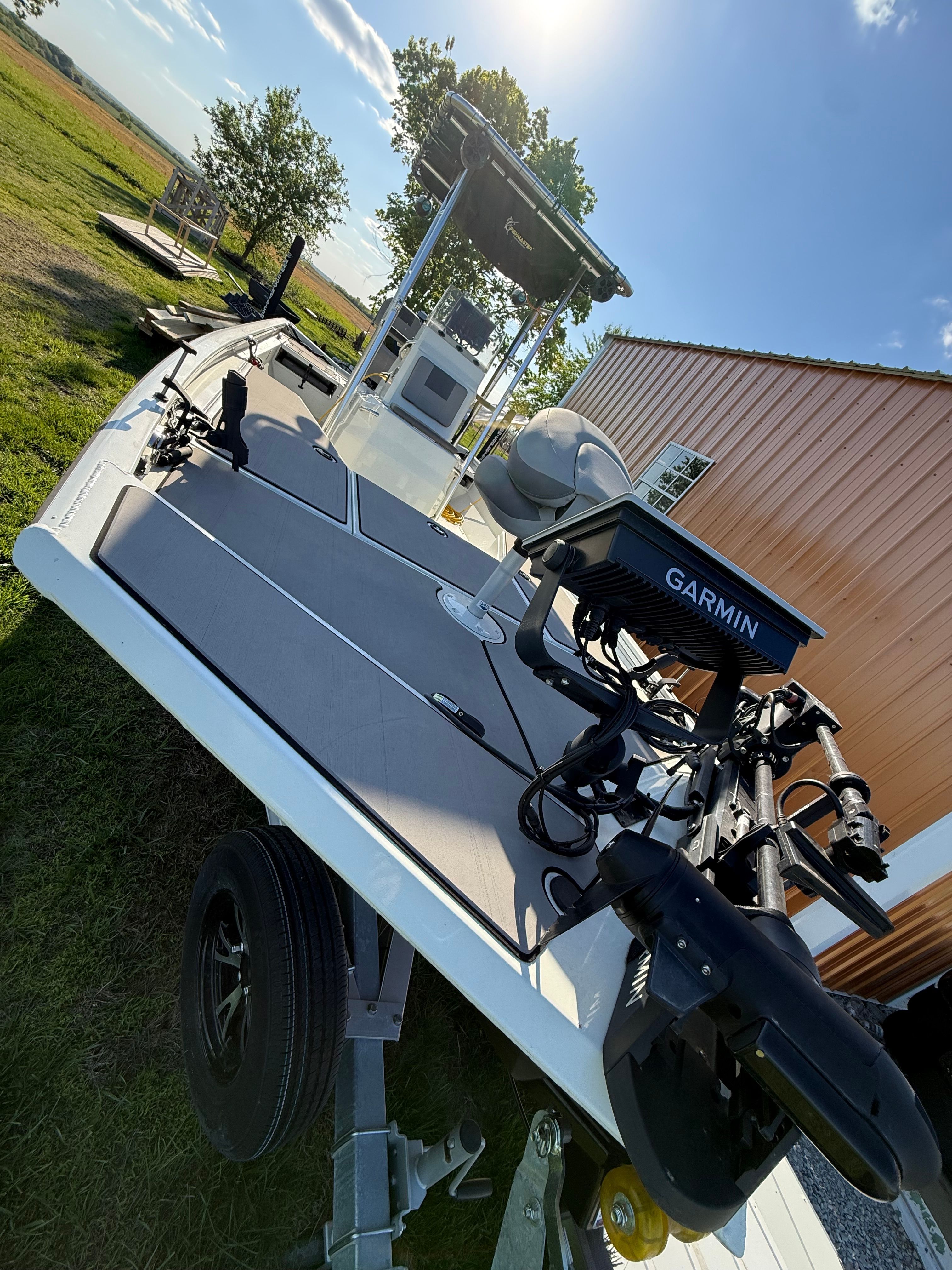 A 2023 Lowe Bay 22 boat on a trailer, featuring Garmin equipment.