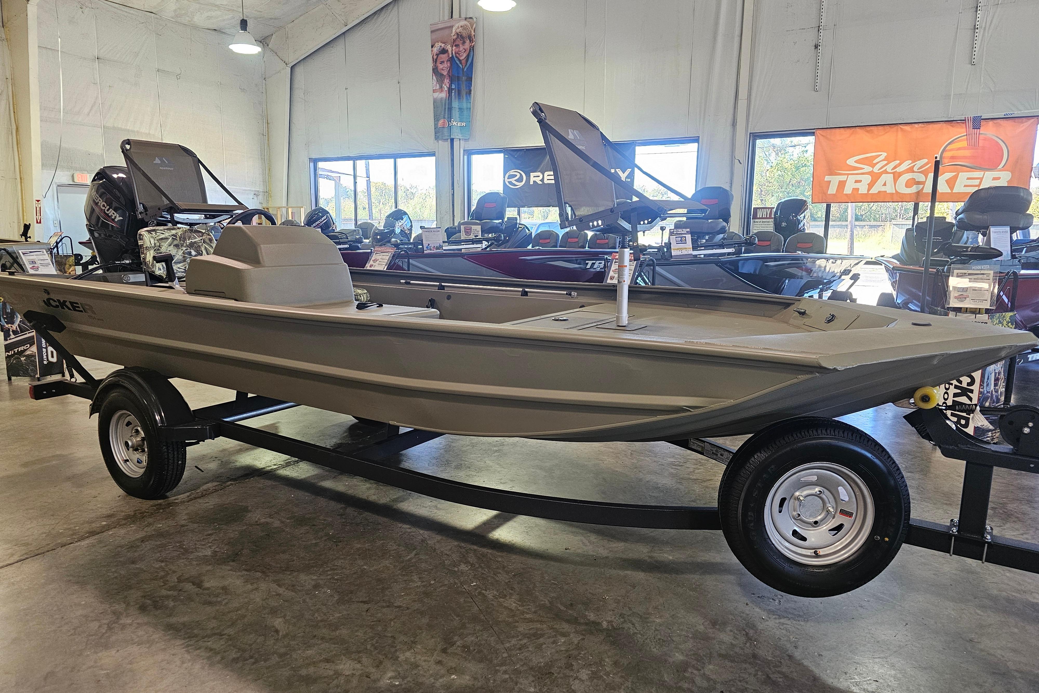 2025 Tracker Grizzly 1754 SC boat on display in a showroom.