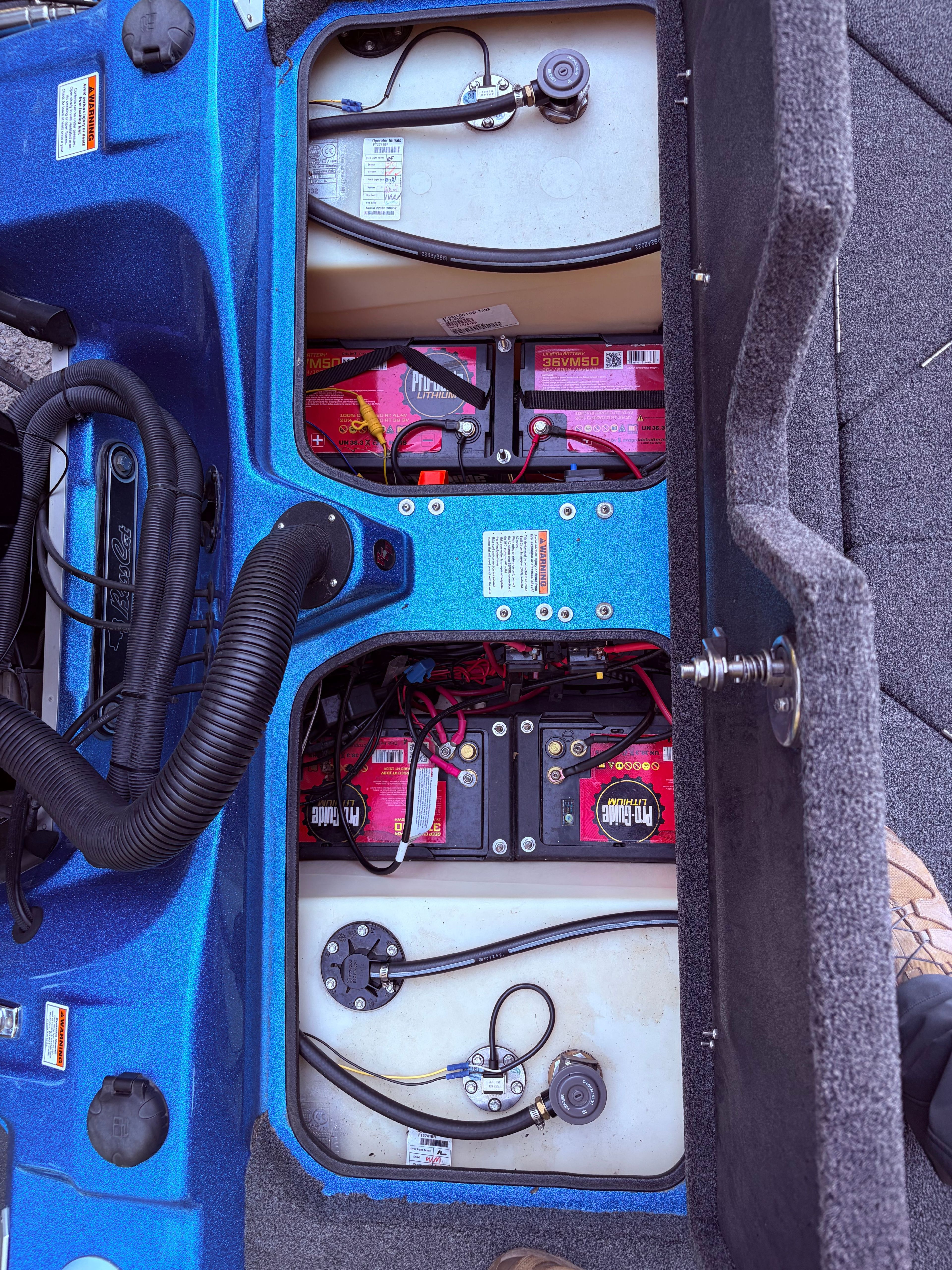 The image shows the battery compartment of a 2023 Bass Cat Cougar FTD boat with two batteries.