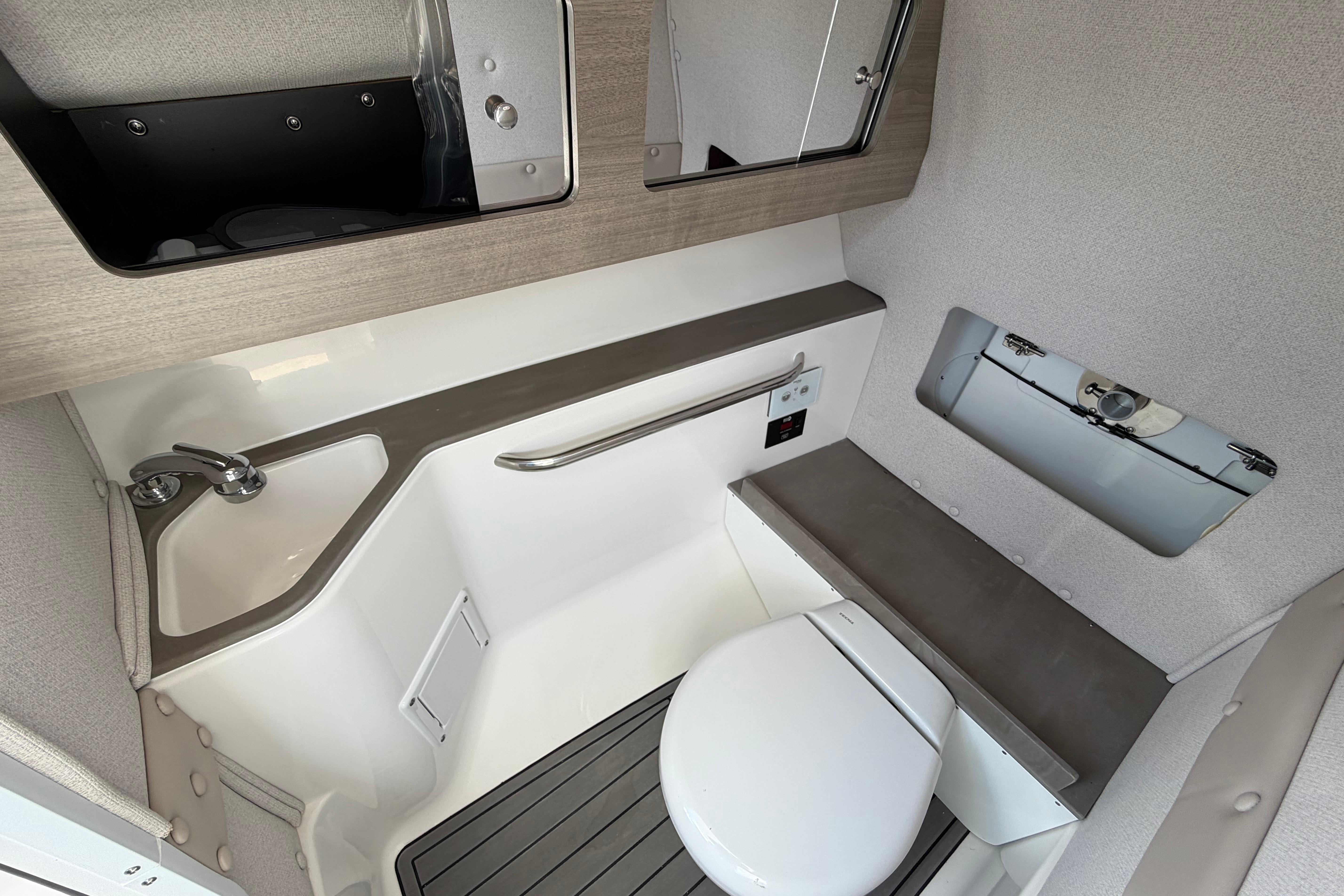 2026 Edgewater 248CX Crossover boat interior with compact bathroom and modern fixtures.