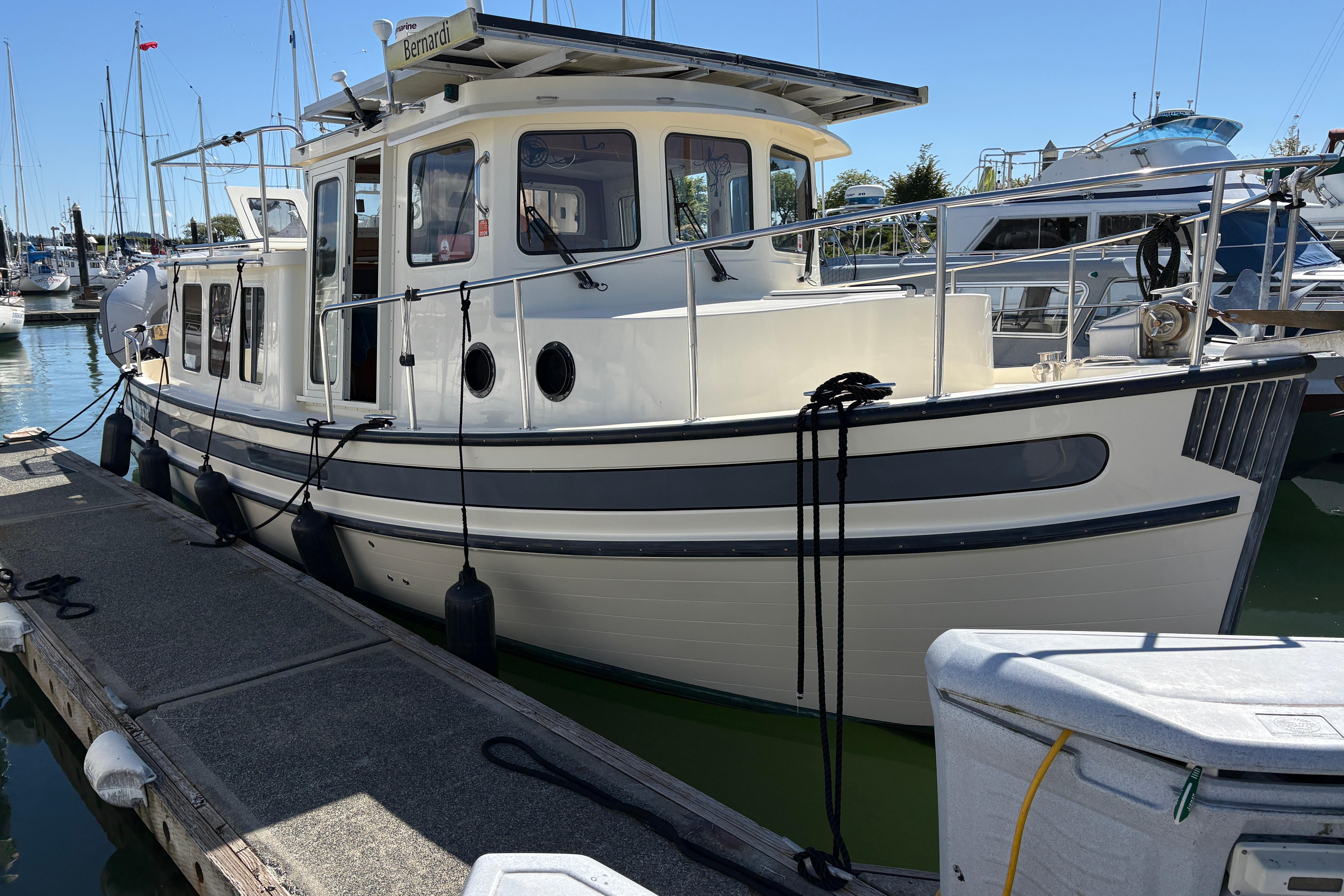 2004 Nordic Tug 32 docked at marina, showcasing classic design and sturdy build.