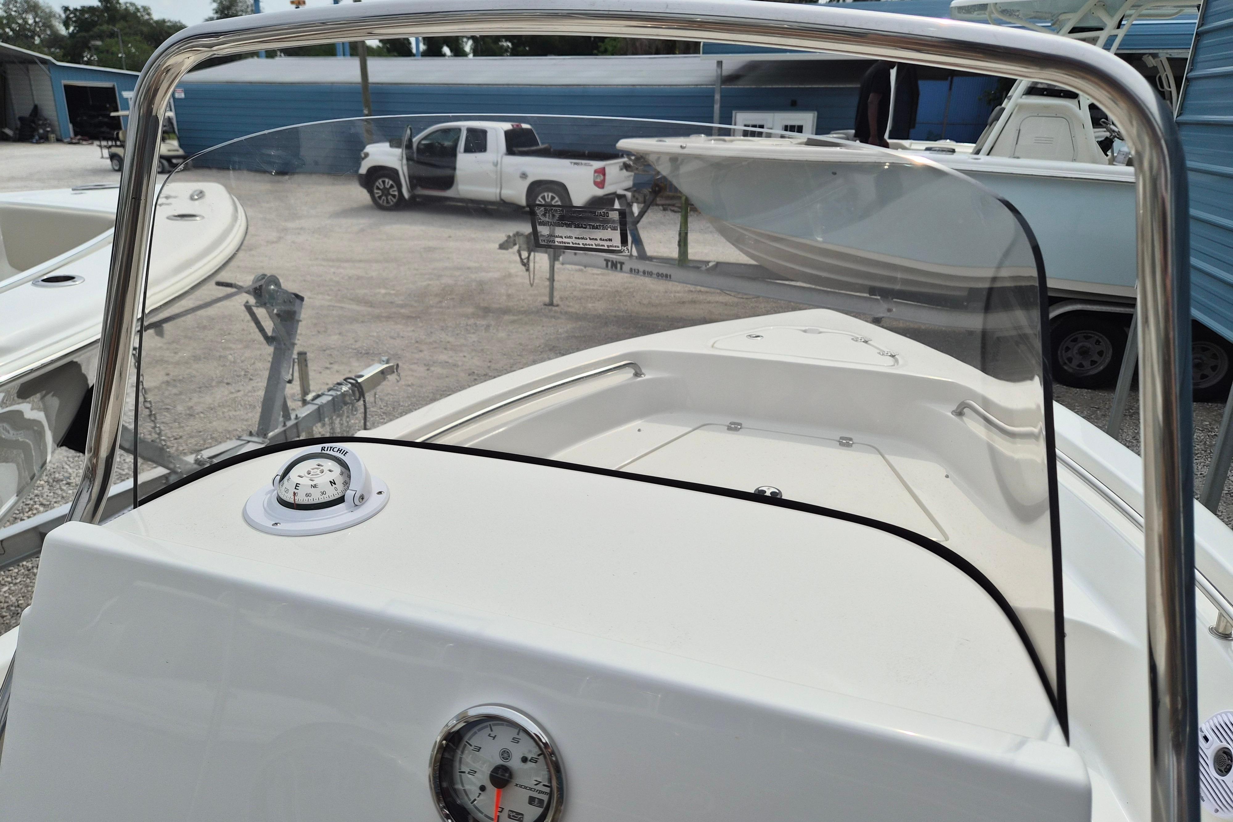 2026 Key West 189 FS boat interior with compass and windshield, parked in a marina.