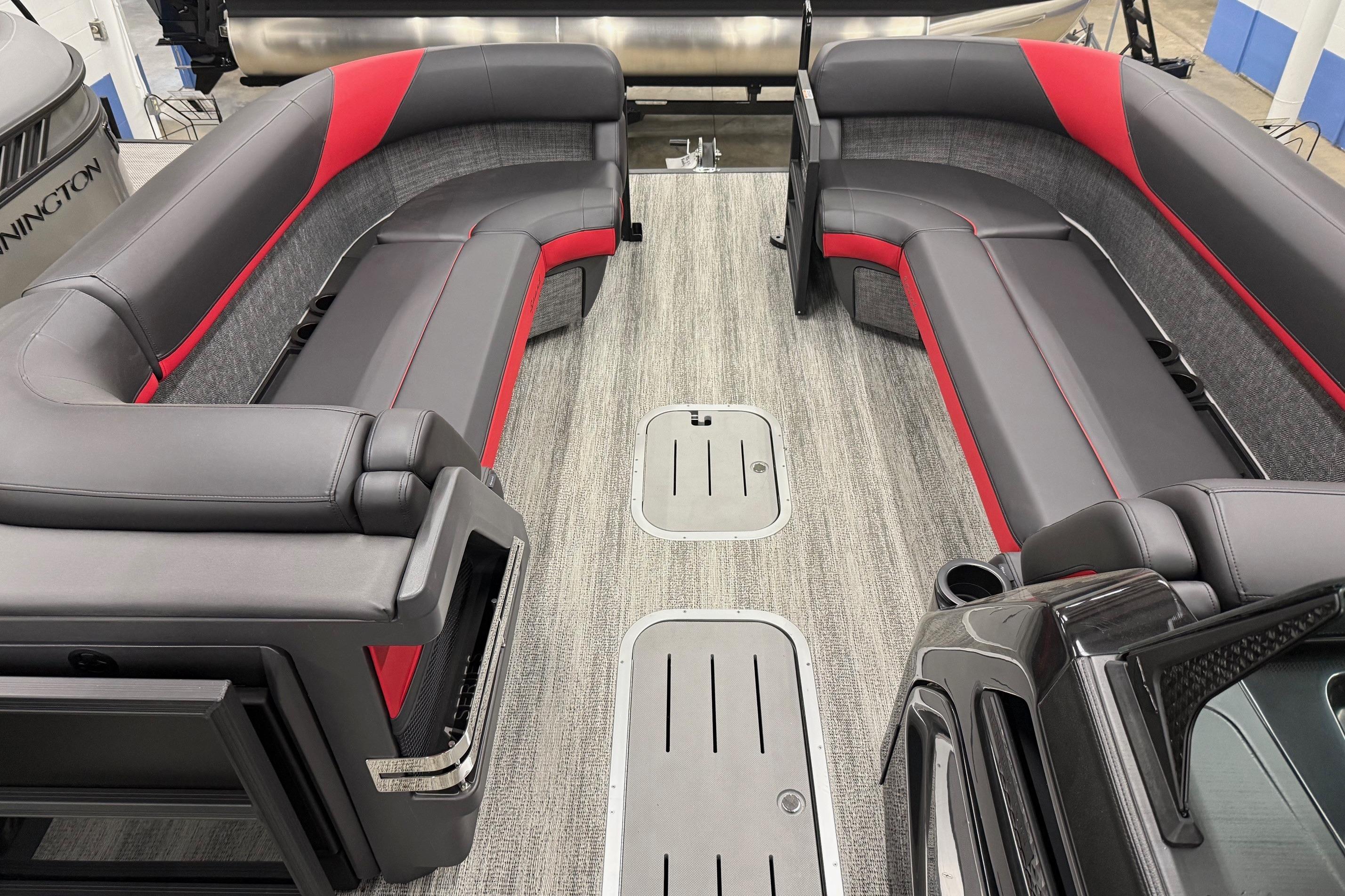 2025 Bennington M Line boat interior with sleek gray and red seating.