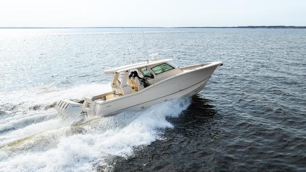 2025 Scout 425 LXF boat cruising on open water, showcasing sleek design and performance.