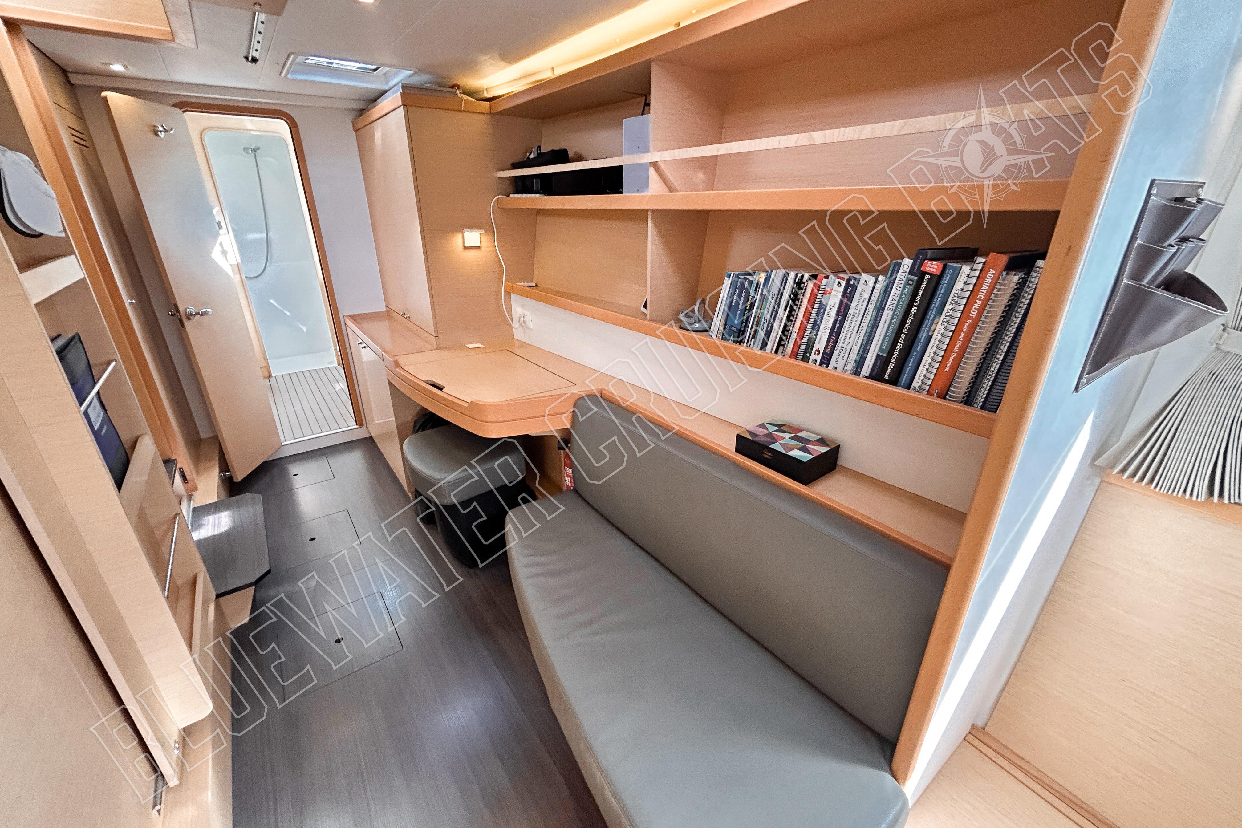 Interior of 2018 Lagoon 42 yacht with bookshelves and seating area.