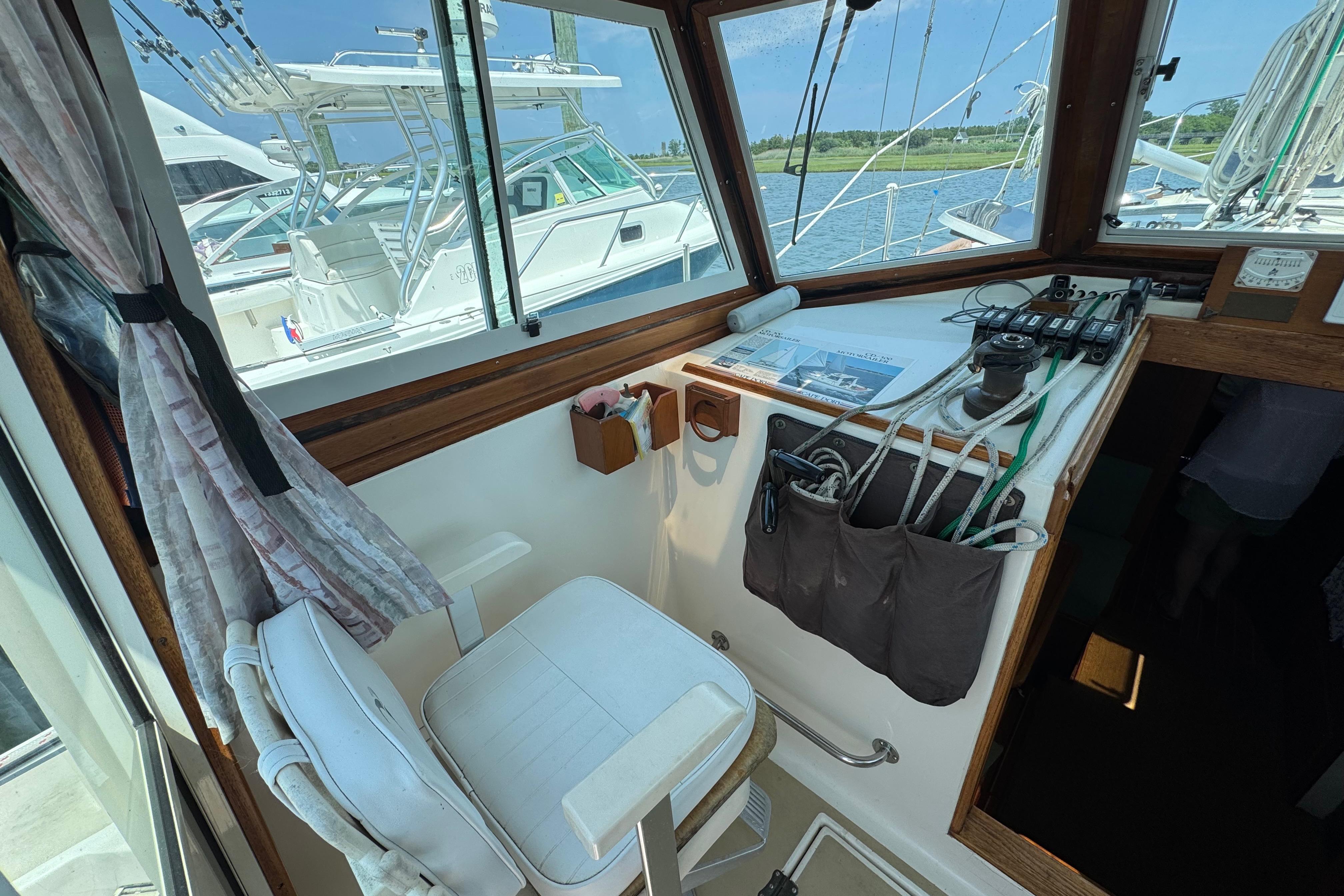 Interior view of 1989 Cape Dory 30 Motorsailer cockpit with helm and seating.