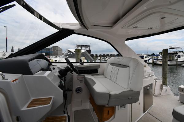2021 Regal 35 Sport Coupe interior with helm and seating, docked at marina.