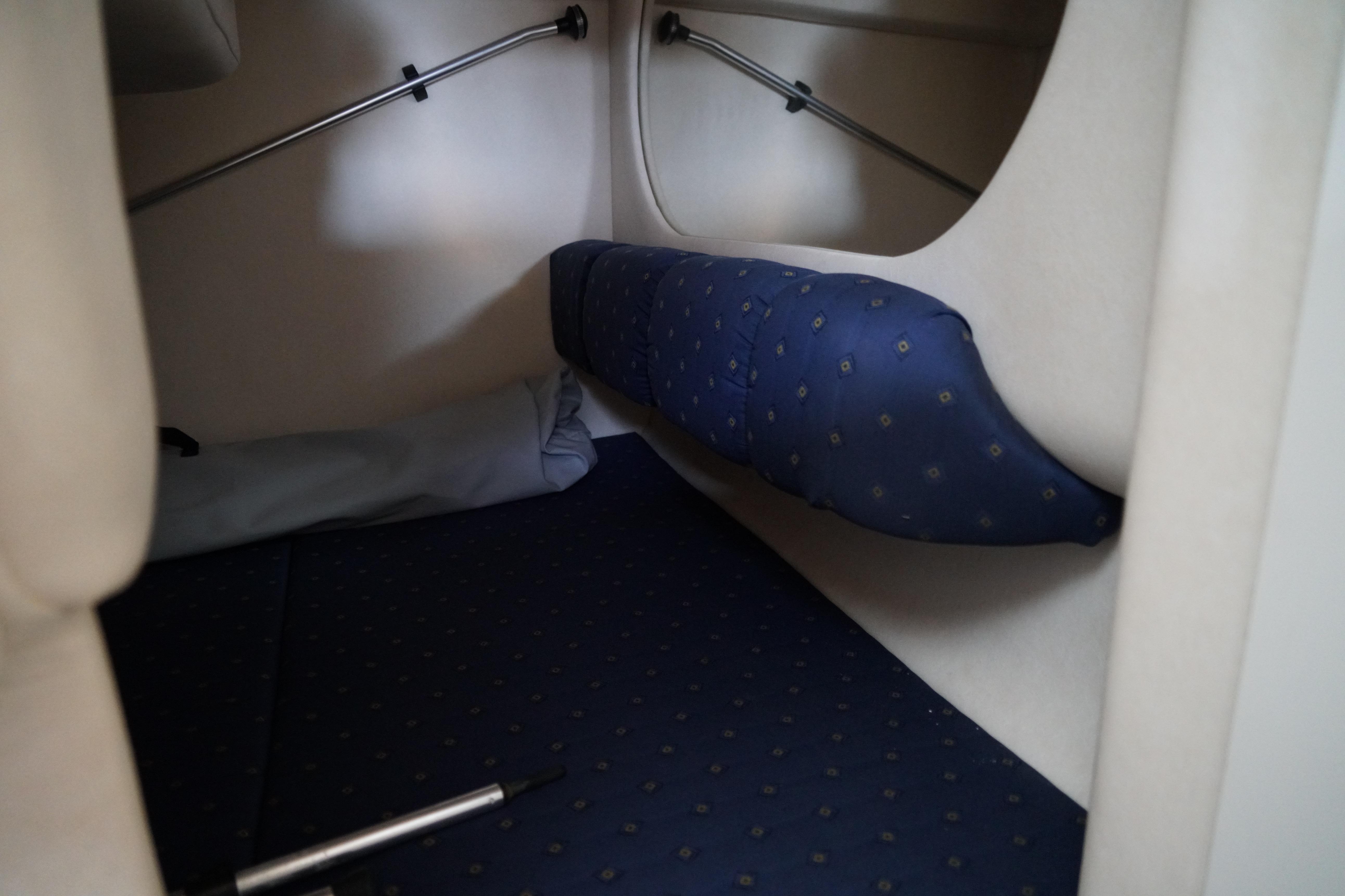 Interior cabin of 2002 Sea Ray Sundancer 260 with blue cushioned seating.