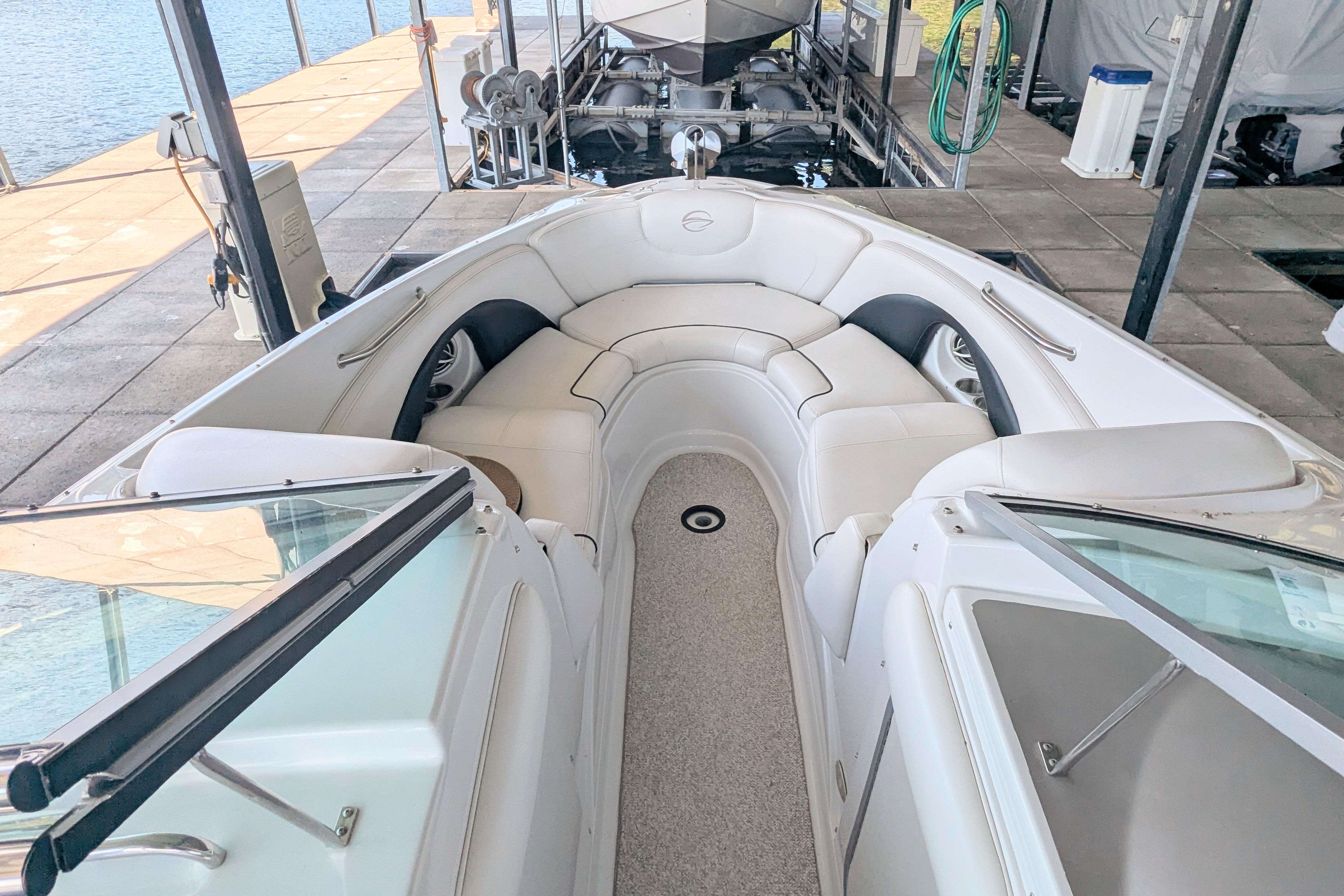 2008 Crownline 300 LS boat interior with white seating, docked at marina.