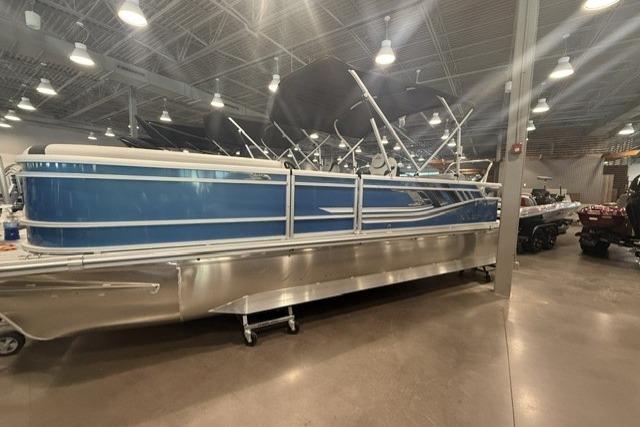 2026 SunCatcher Select 322SL pontoon boat displayed indoors, featuring a sleek blue design.