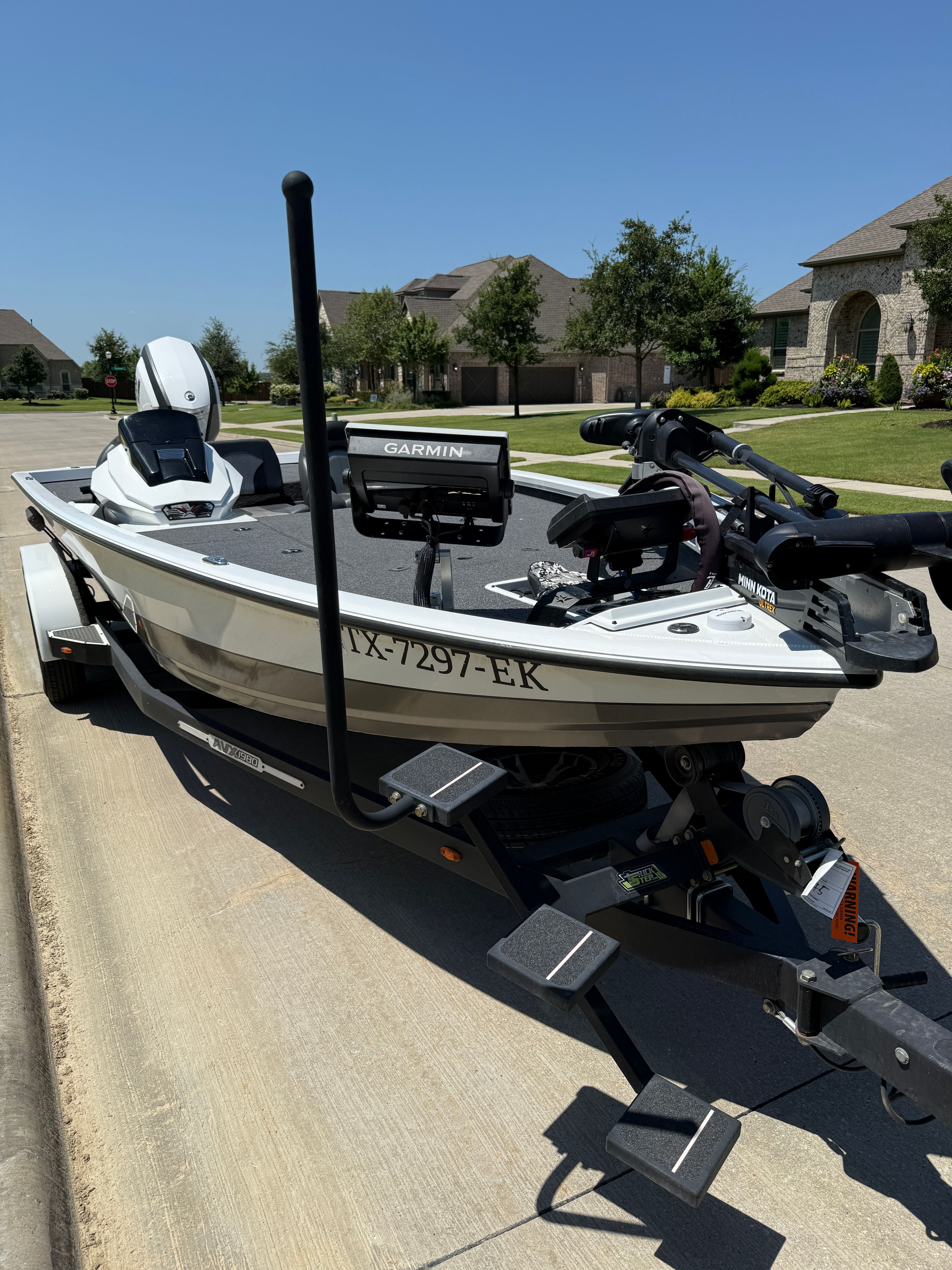 A 2019 Vexus AVX1980 boat on a trailer in a residential area.