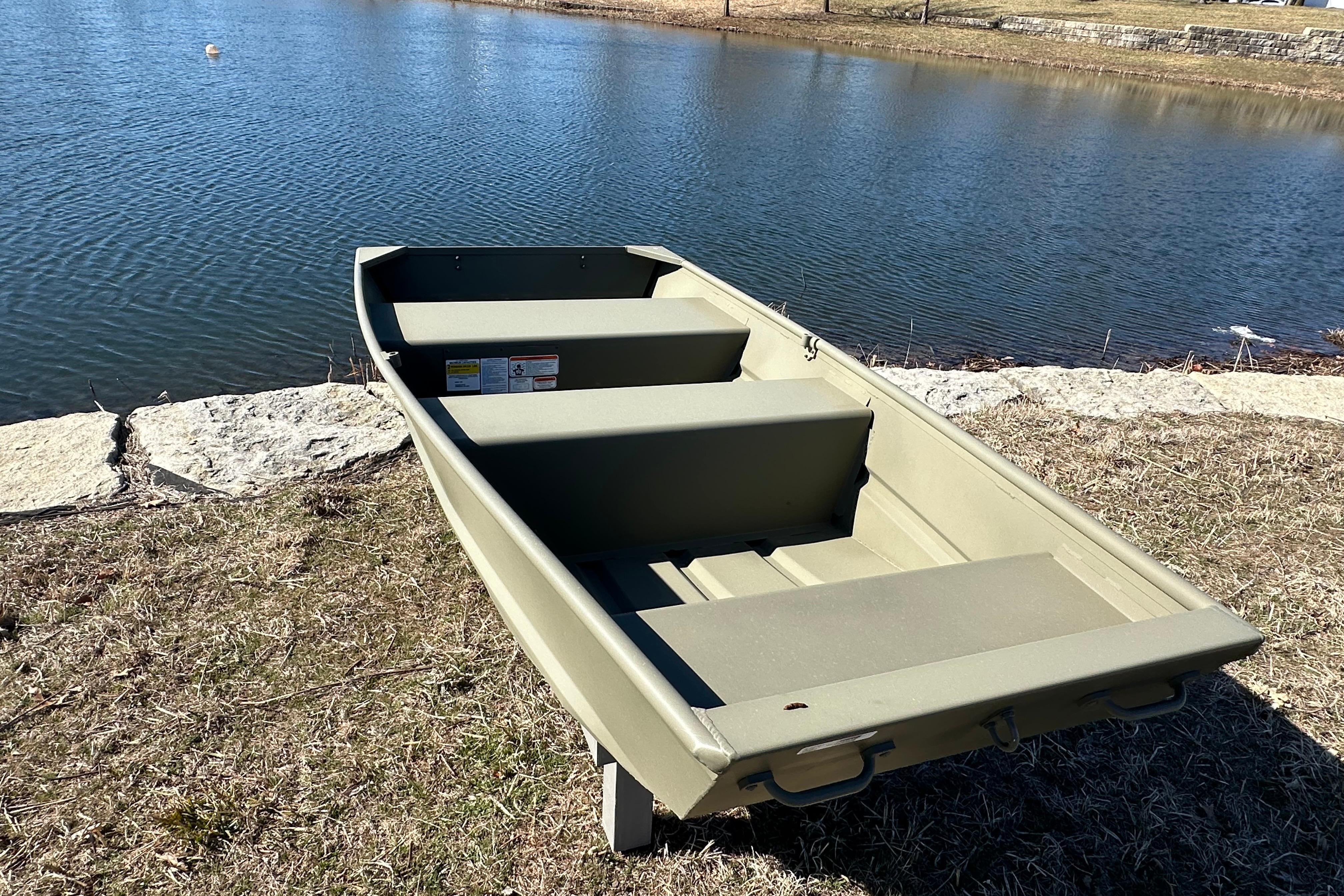 2026 Tracker Grizzly 10 Jon boat by a serene lakeside.