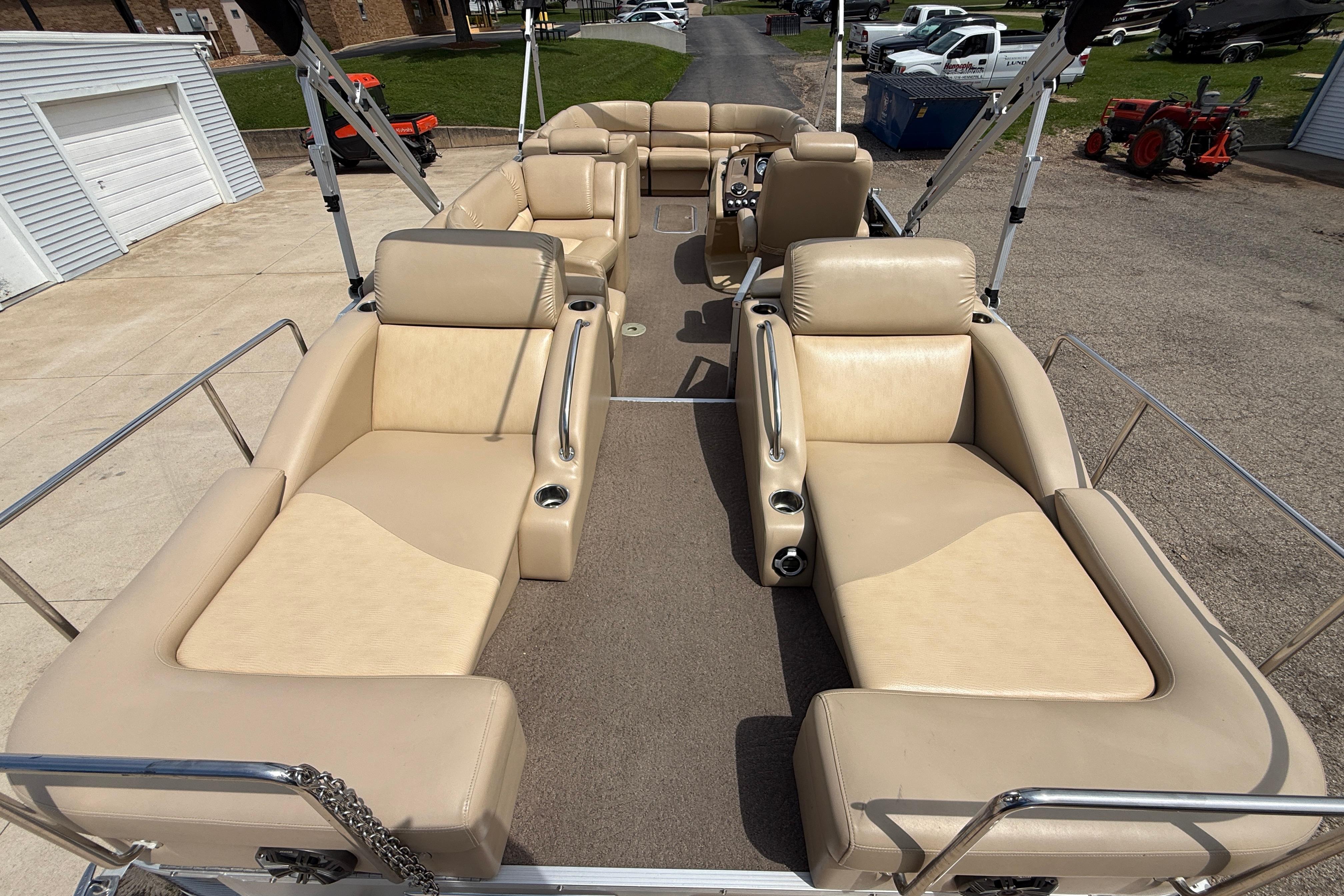 2011 Bennington 2575QCW I/O pontoon boat with beige seating and spacious layout.