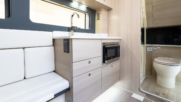 Modern interior of 2025 Scout 425 LXF with kitchenette and seating area.