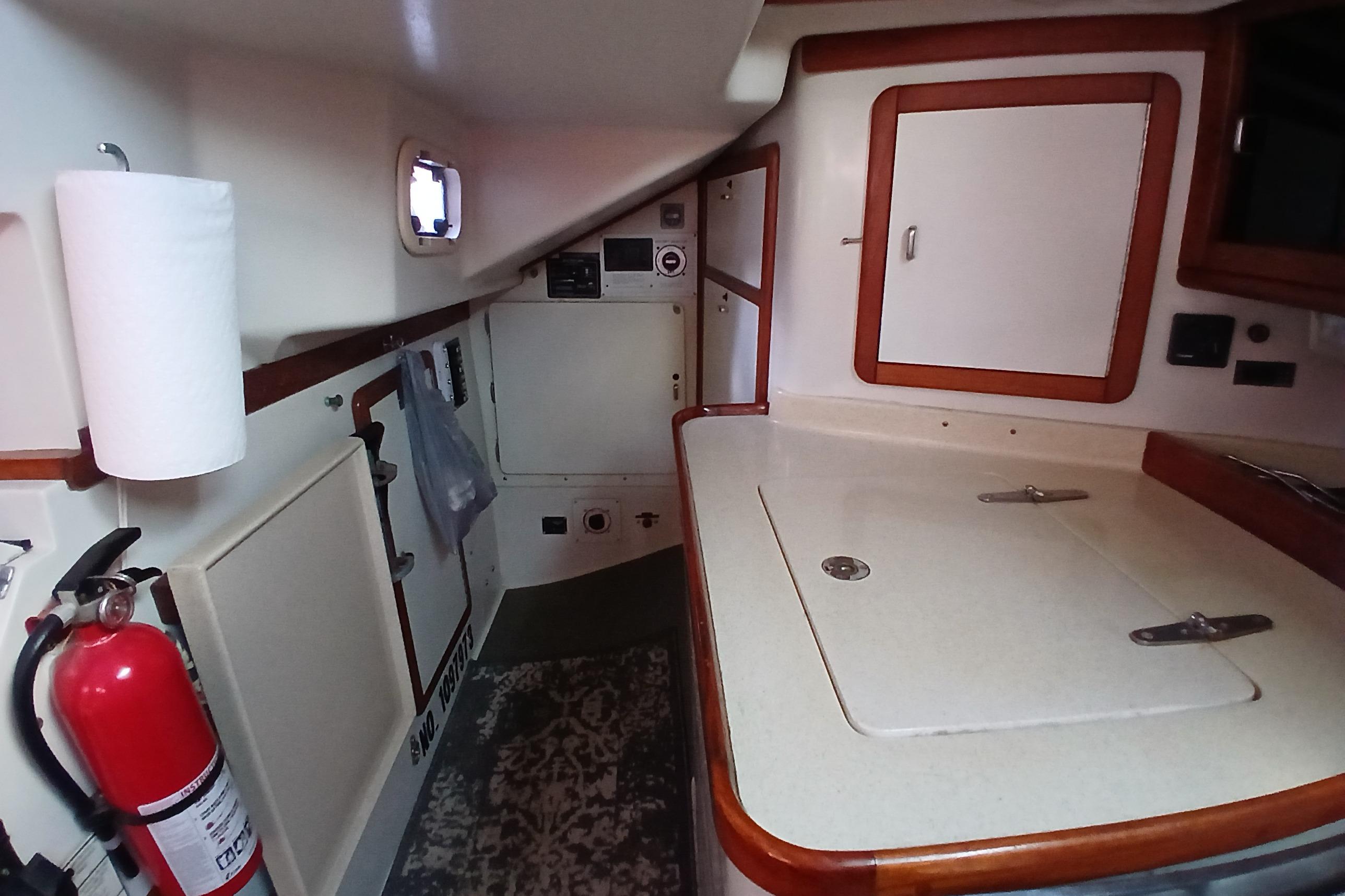 Interior of a 1995 Catalina 42 MkII sailboat, featuring a compact galley area.