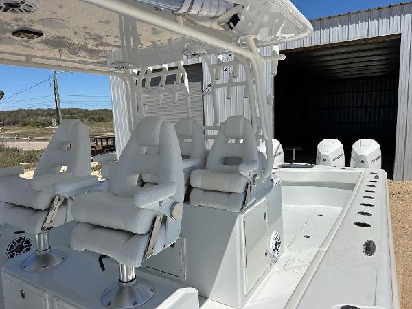 2022 Freeman 42LR boat with white seating and multiple outboard engines.