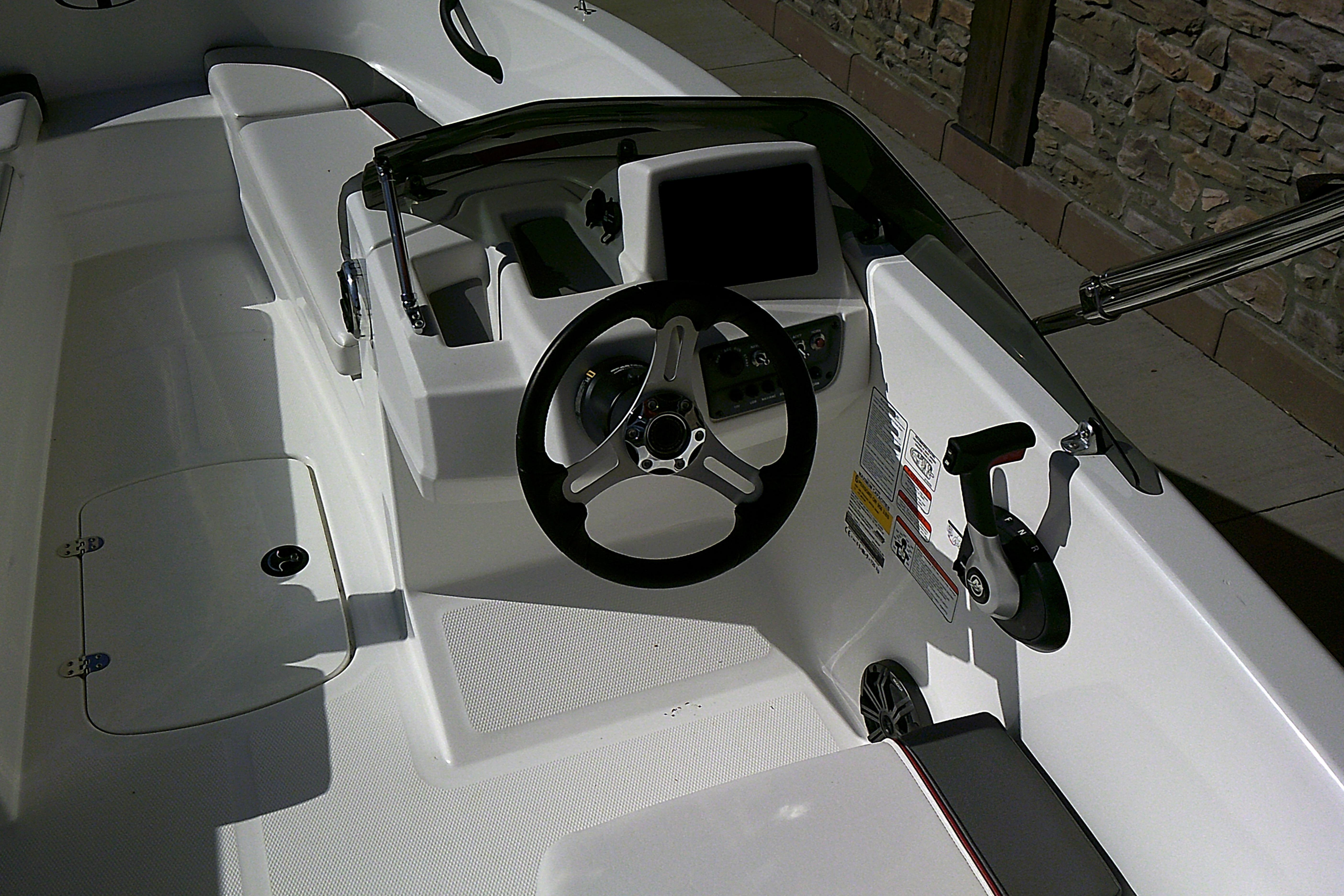 2025 Tahoe T16 boat cockpit with steering wheel and control panel.