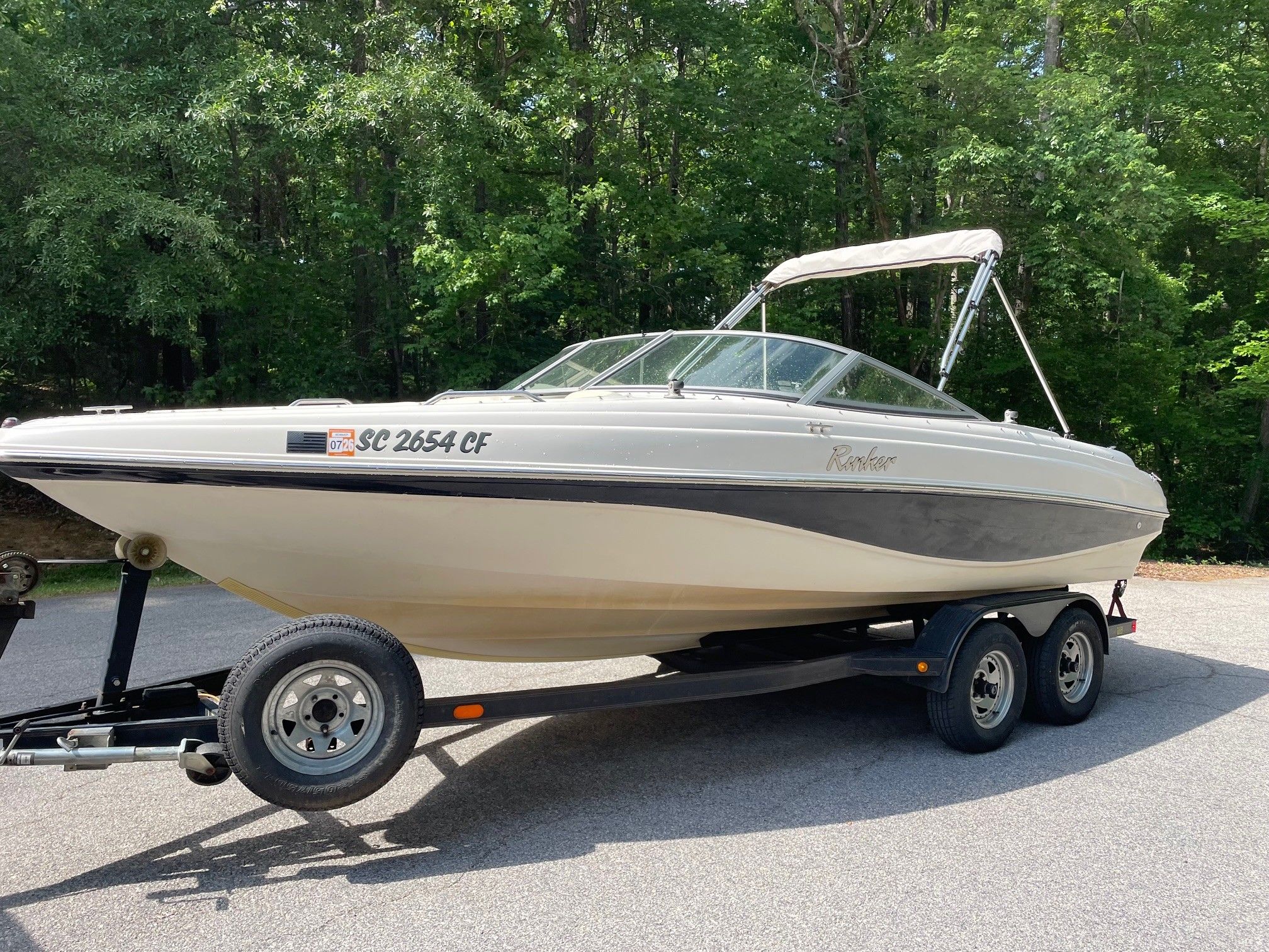 2002 Rinker 212 Captiva Bowrider on trailer outdoors.