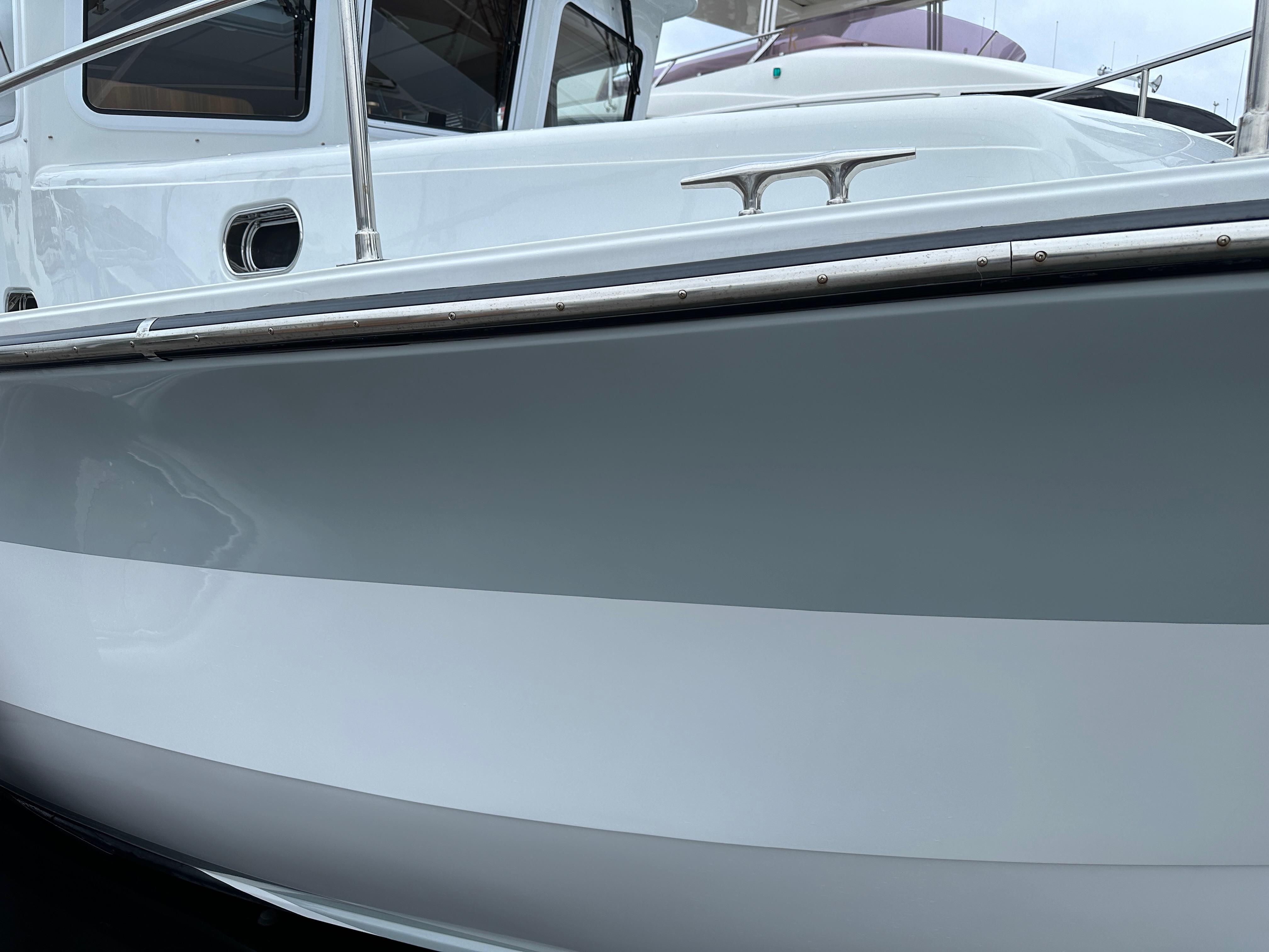 2023 Helmsman Trawlers 43E Pilothouse, sleek white and gray hull detail.