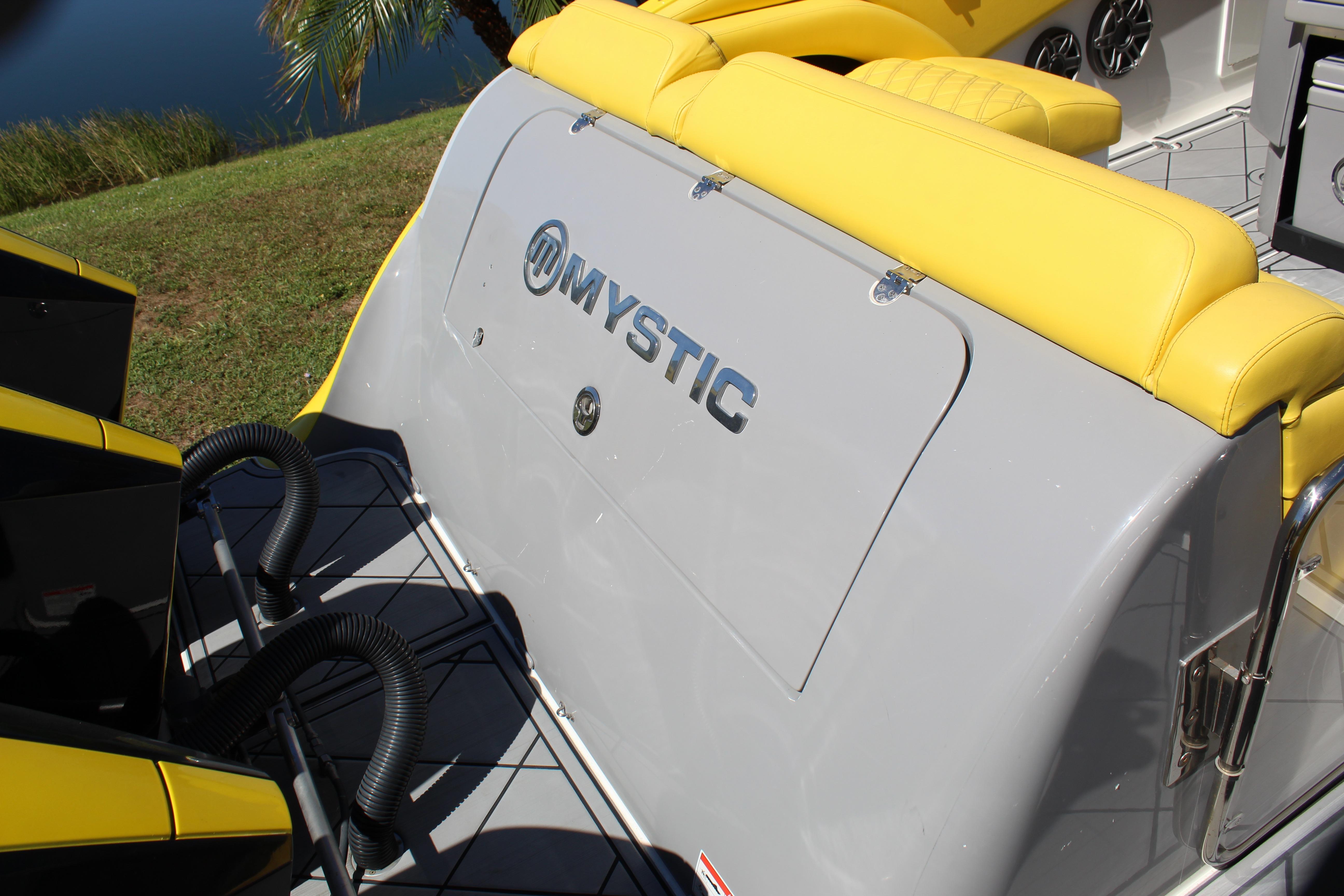 2021 Mystic M4200 boat with yellow seating and sleek design.
