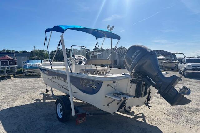2015 Carolina Skiff 198 DLV boat with Yamaha outboard motor and blue canopy.