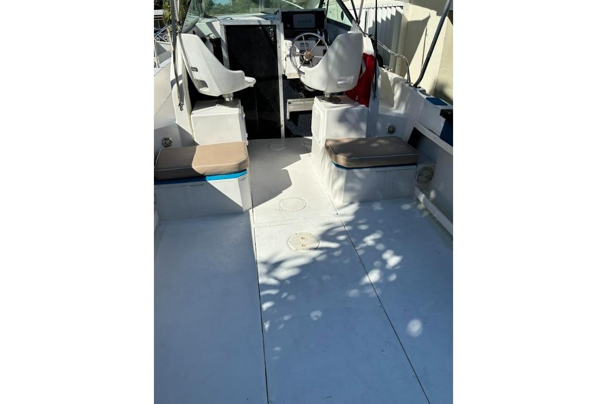 1989 Grady-White Offshore 242 boat interior with seating and steering wheel.