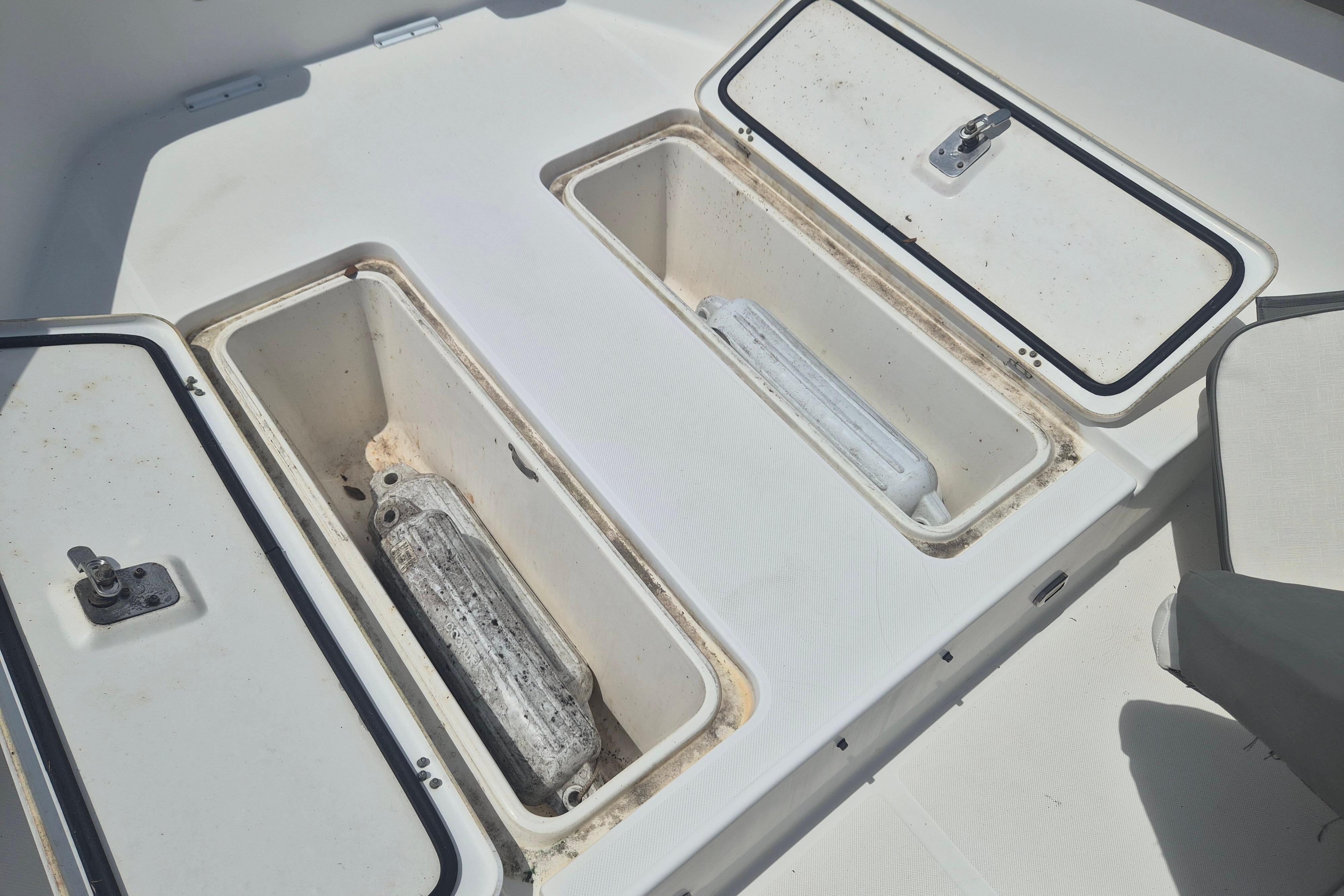 Storage compartments on a 2006 Century 2900 Center Console boat deck.