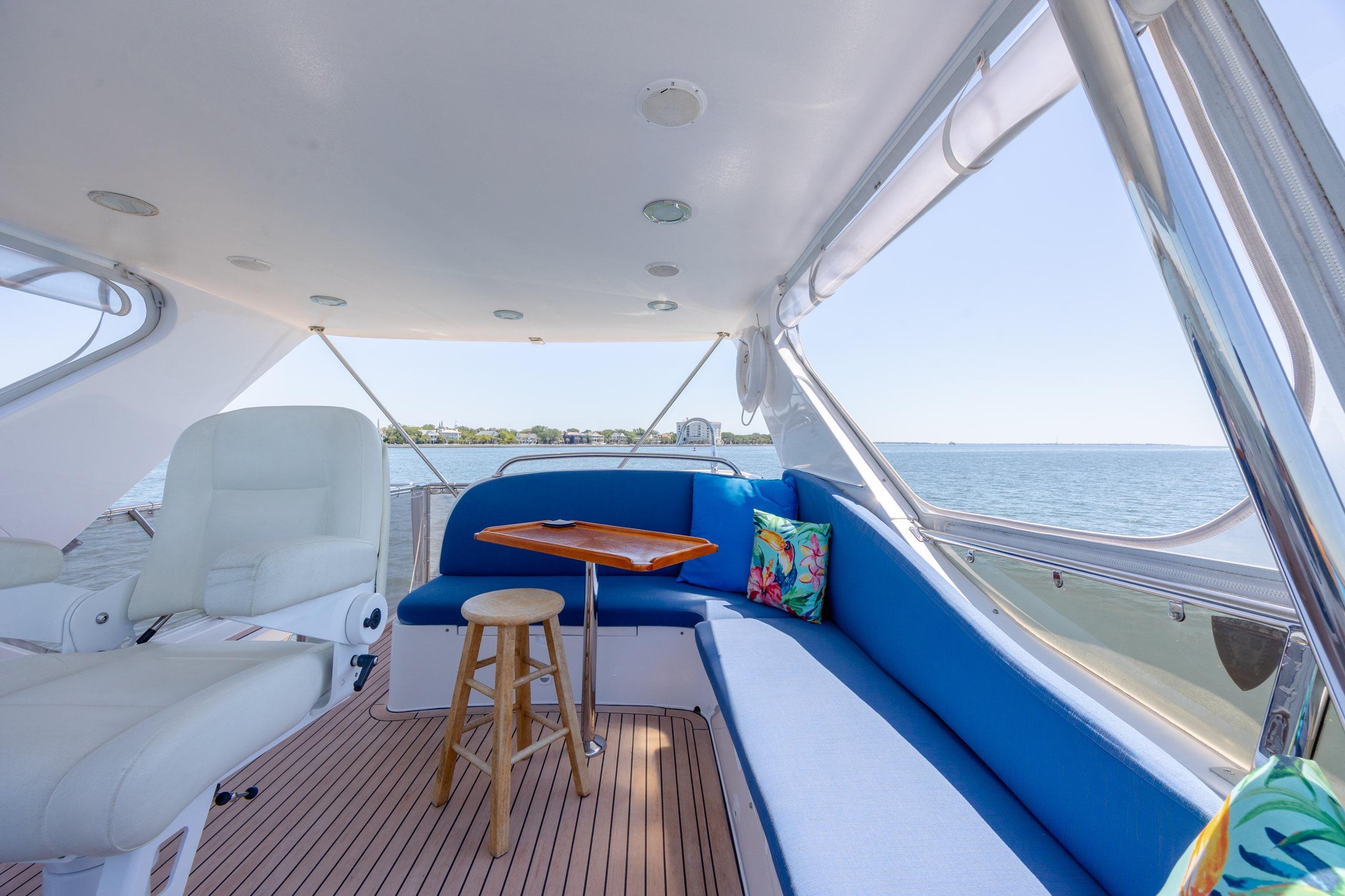 Luxurious 2005 Ocean Alexander 52 Sedan yacht interior with blue seating and ocean view.