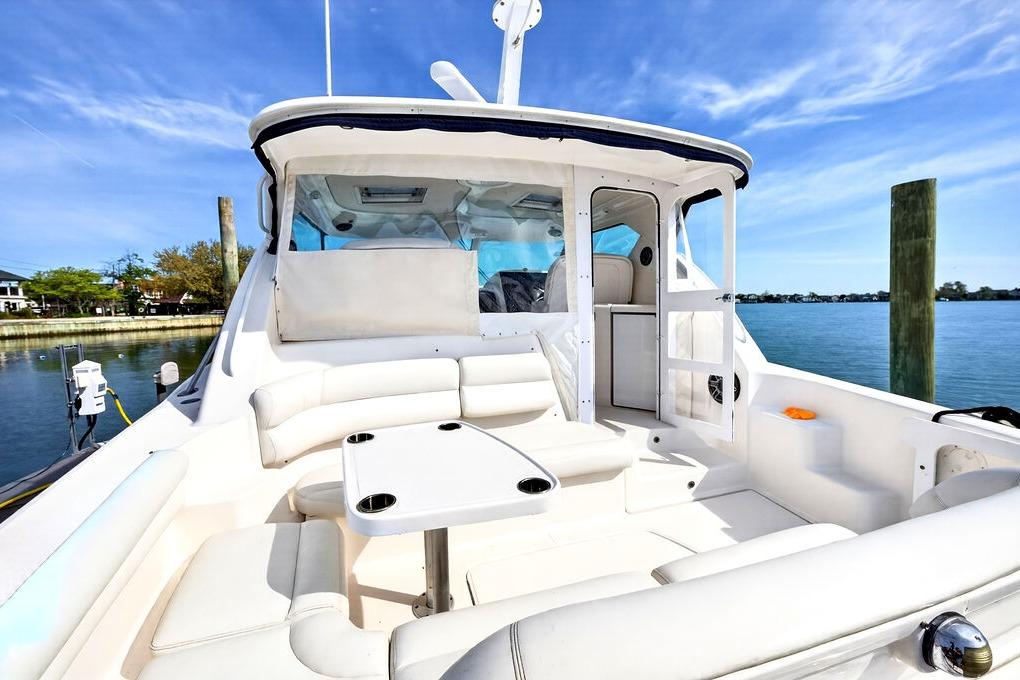 2006 Tiara Yachts 4300 Sovran with spacious deck and seating, docked by the water.