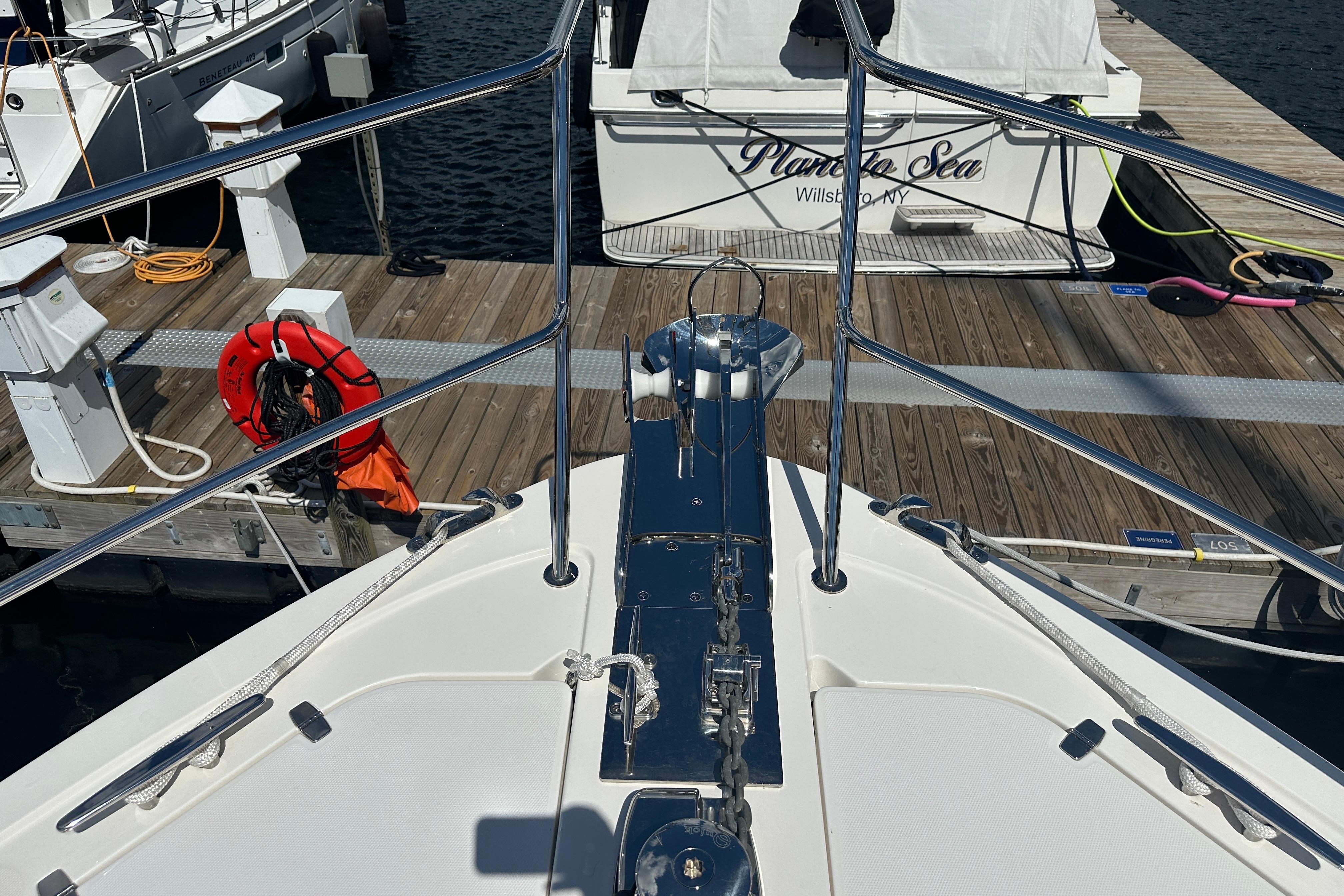 Bow view of 2025 Sabre 48 Salon Express yacht docked at marina.