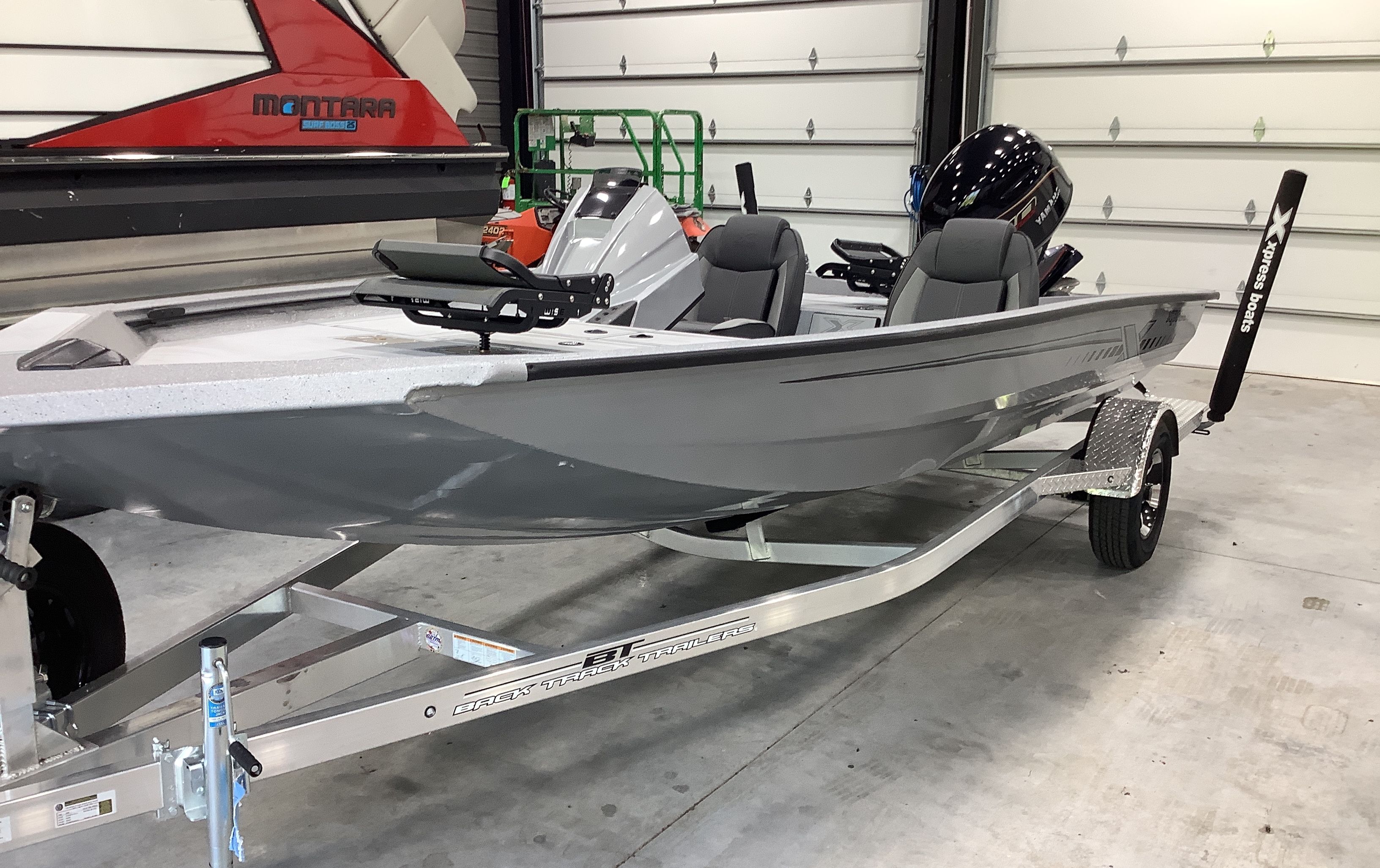 2026 Xpress Boats H18C on trailer in garage.