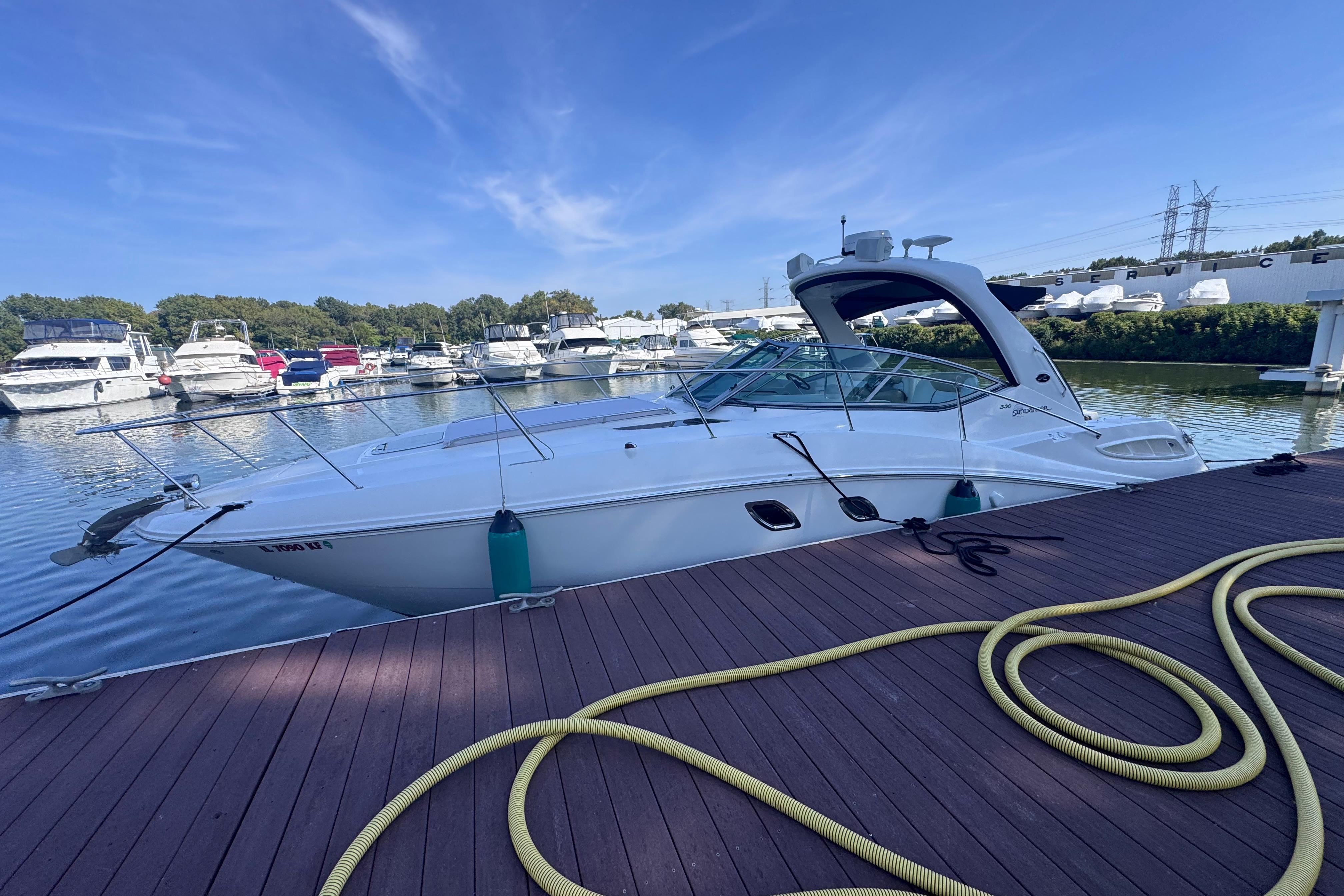 2008 Sea Ray 350 Sundancer docked at marina, surrounded by other boats.