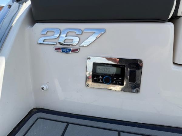 2023 Chaparral 267 SSX boat dashboard with control panel and model emblem.