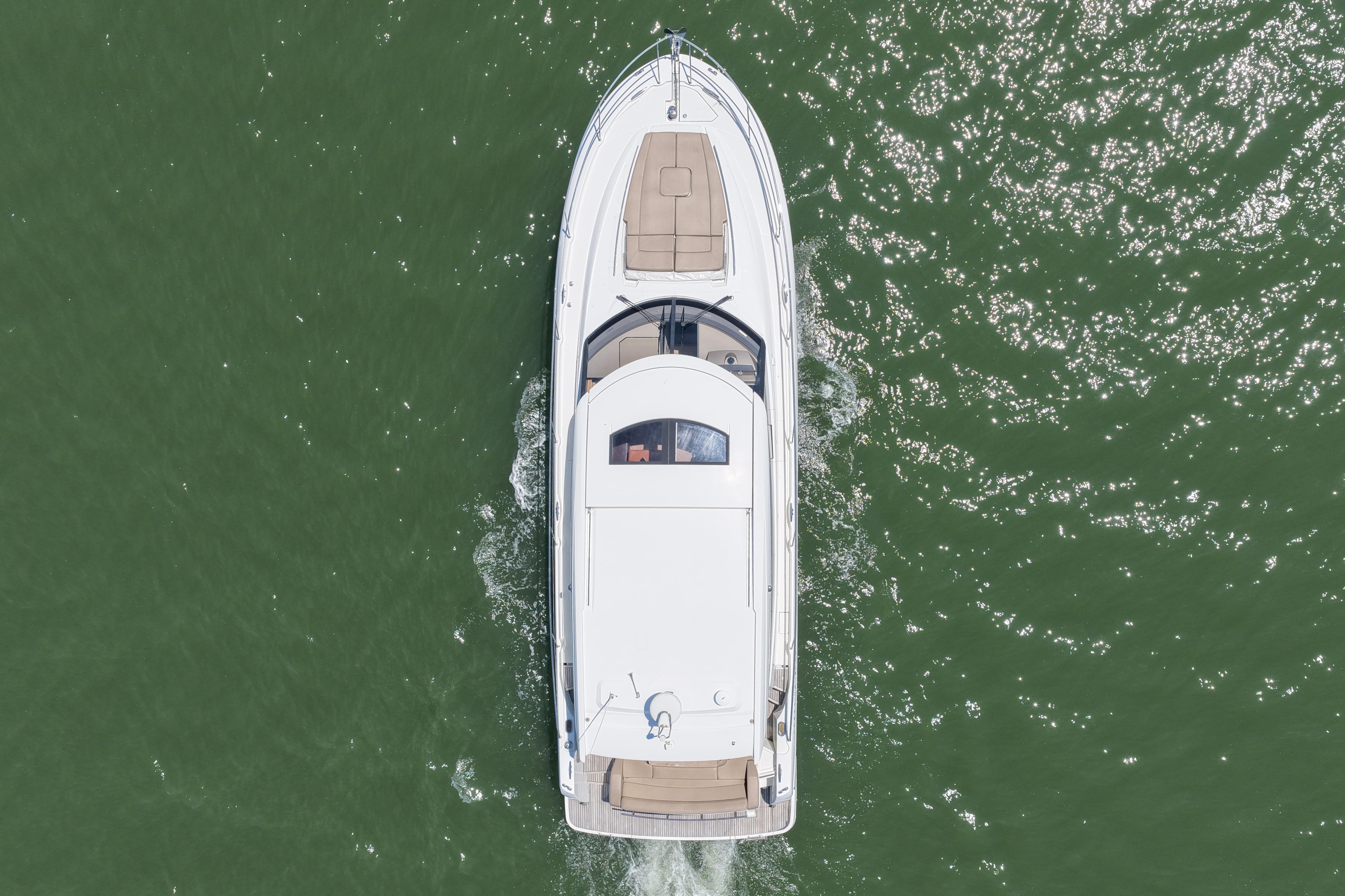 Aerial view of 2015 Prestige 500S yacht cruising on green water.