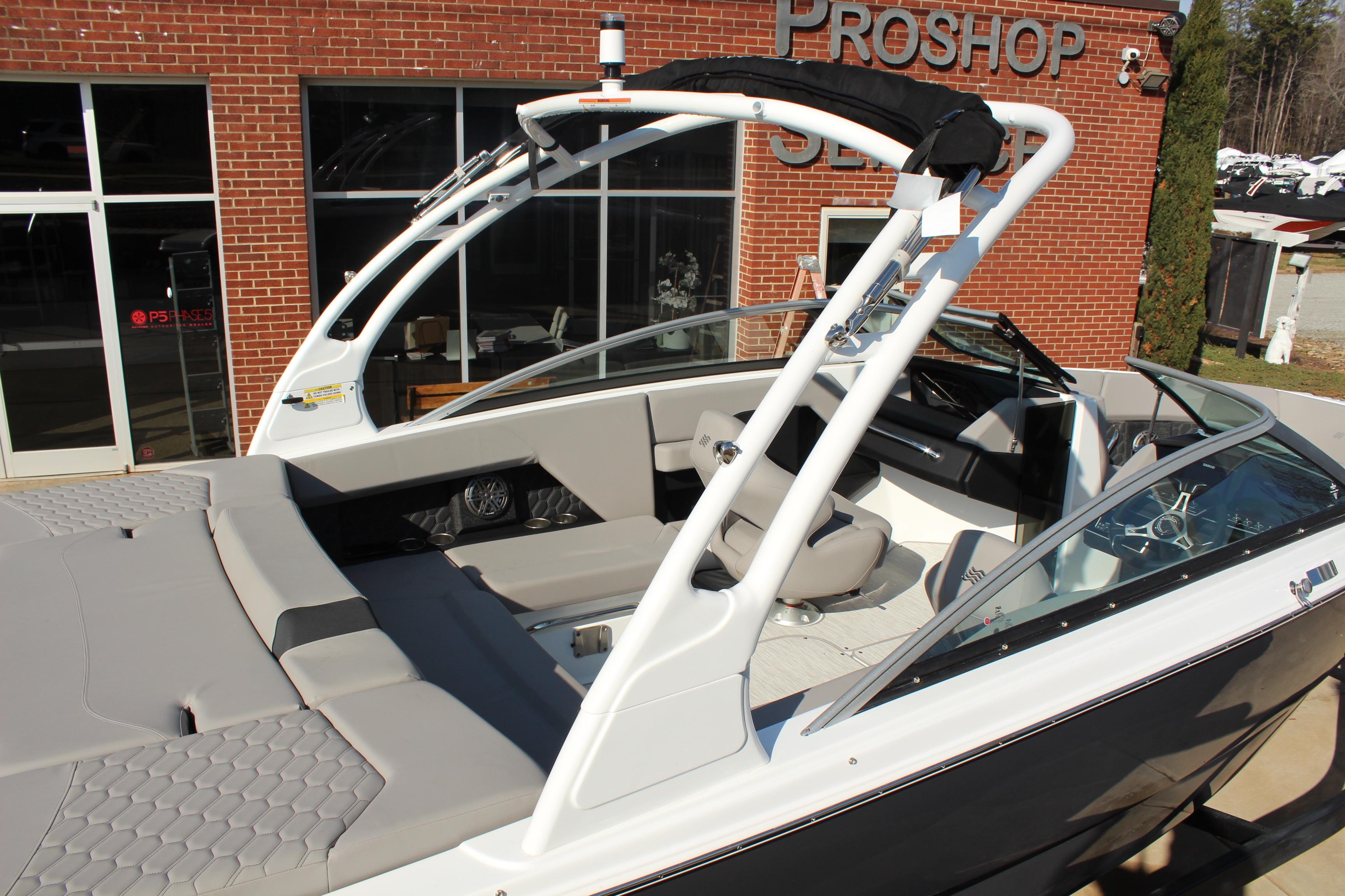 2026 Four Winns H4 boat with sleek design, showcased outside a brick building.