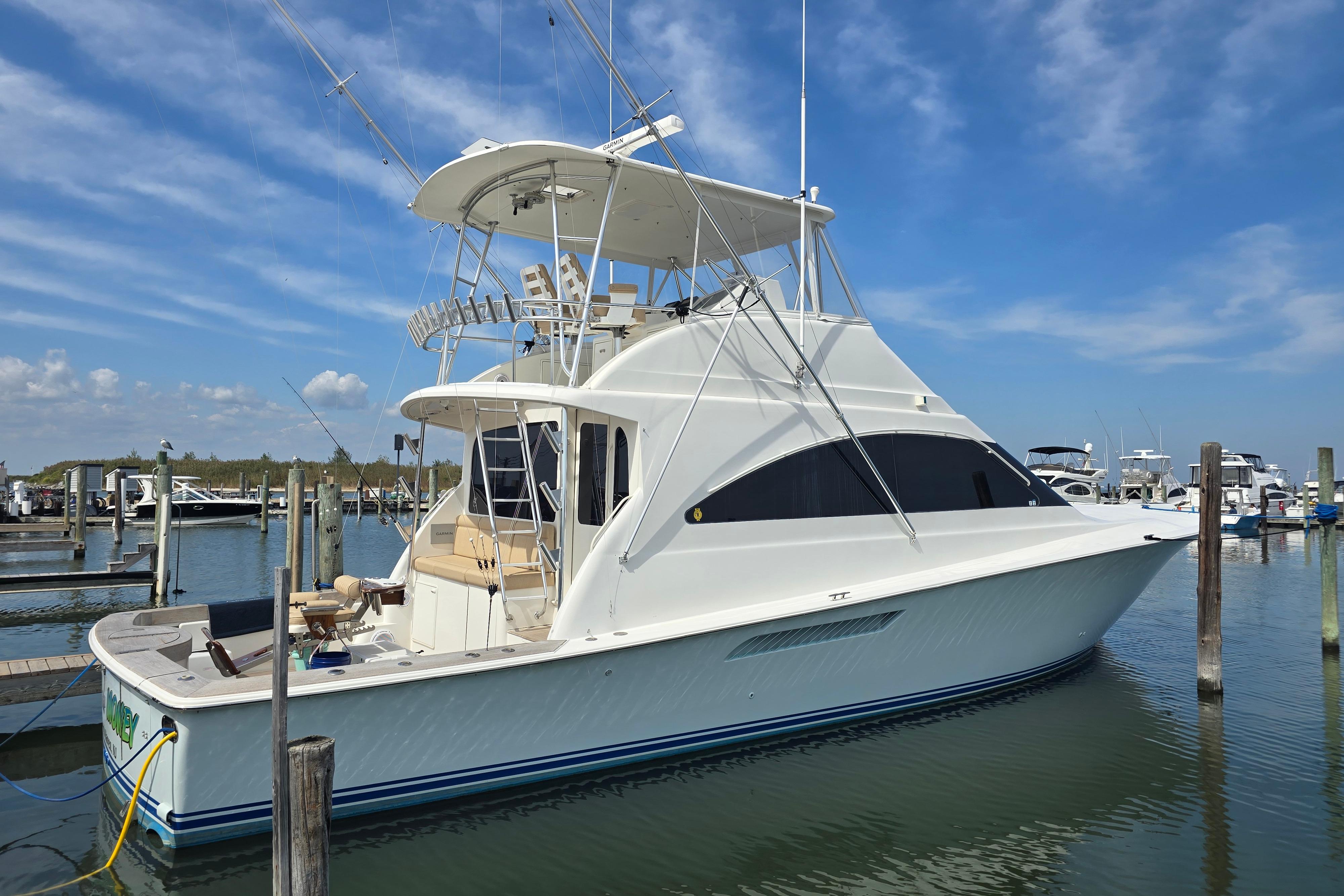 2004 Ocean Yachts 50 Super Sport docked at marina under blue sky.