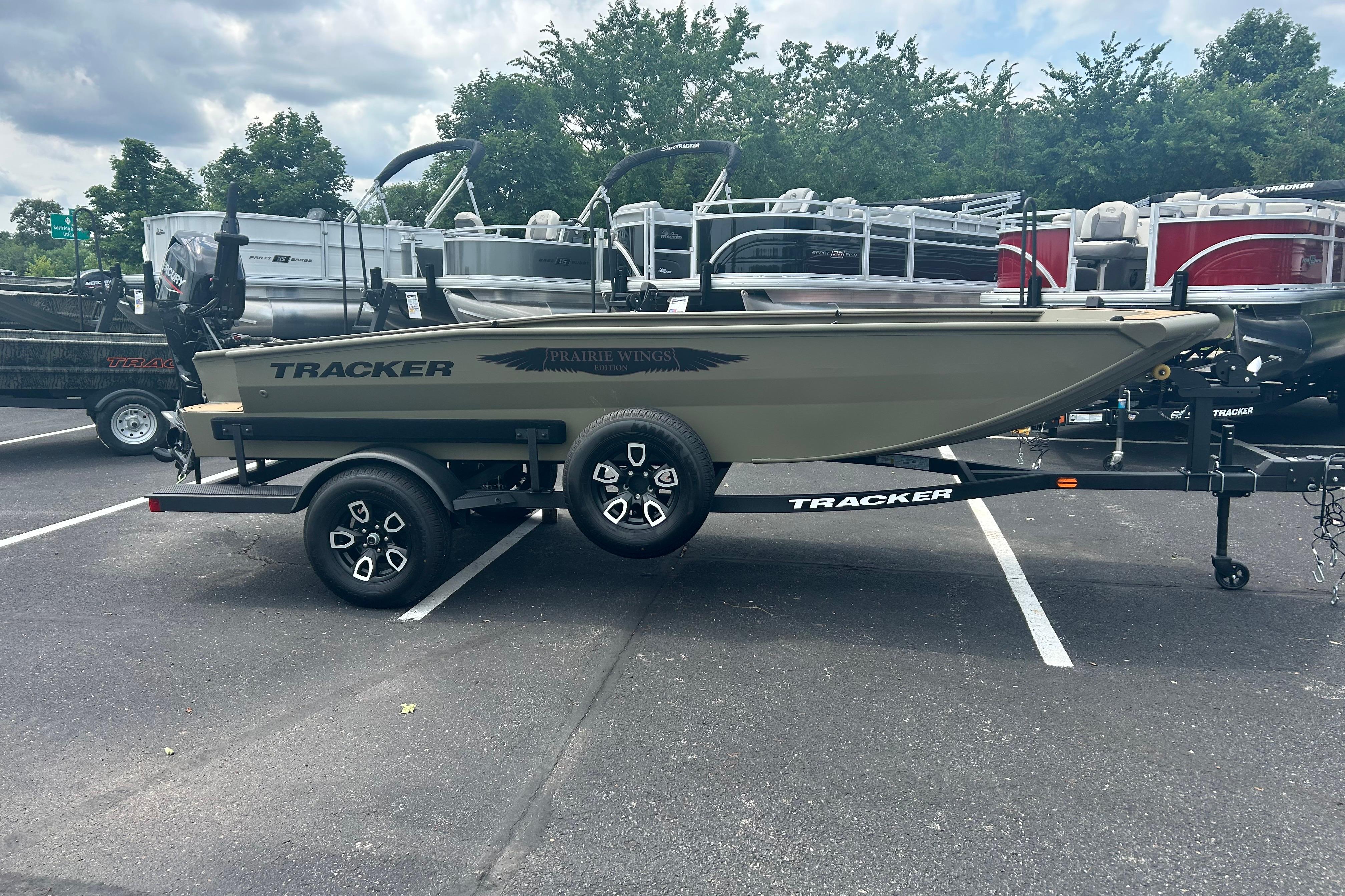 2026 Tracker Grizzly 1650 T Prairie Wings Edition boat on trailer in parking lot.