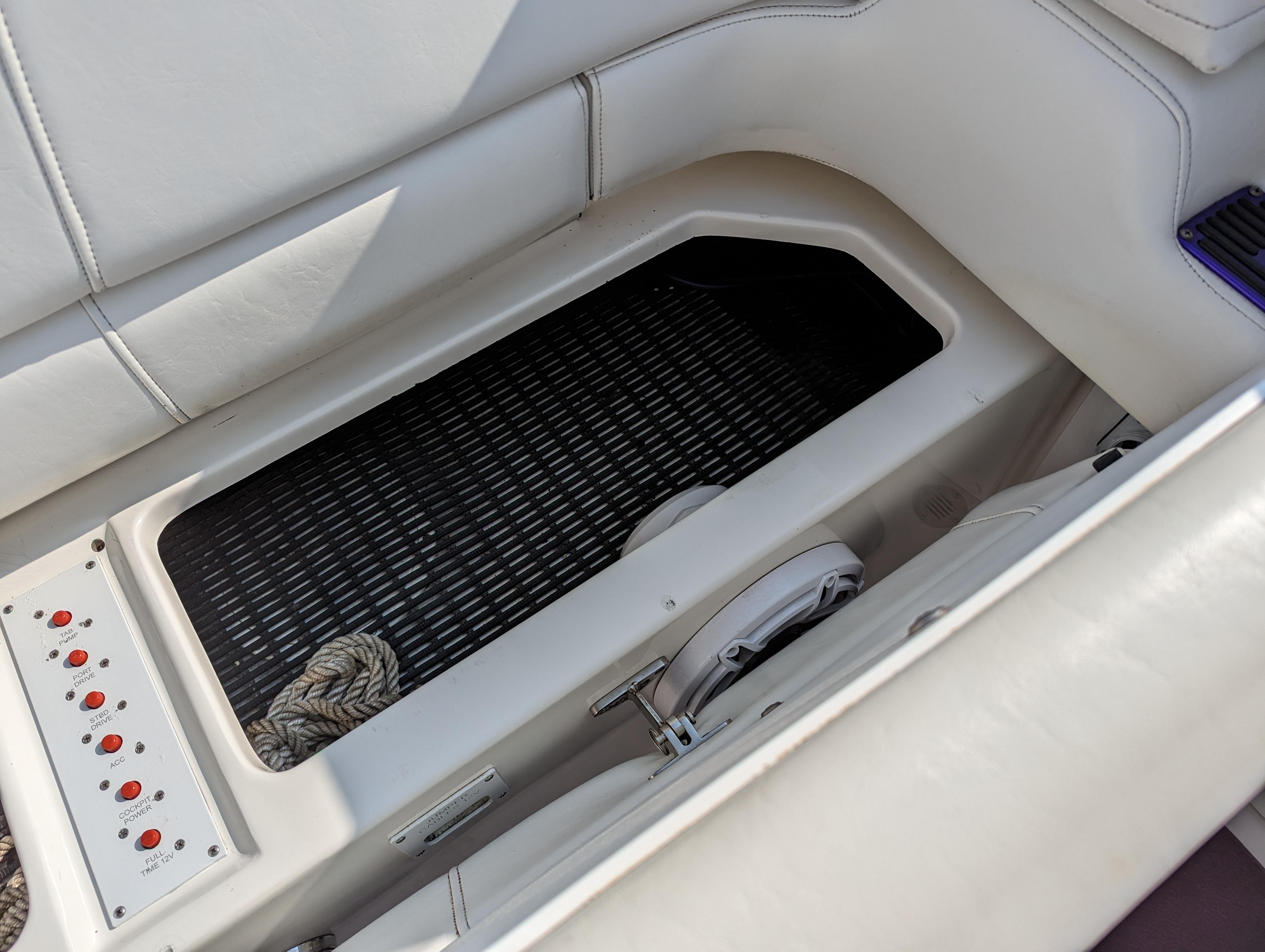 Interior view of a 2006 Fountain 42 boat, featuring seating and control panel.