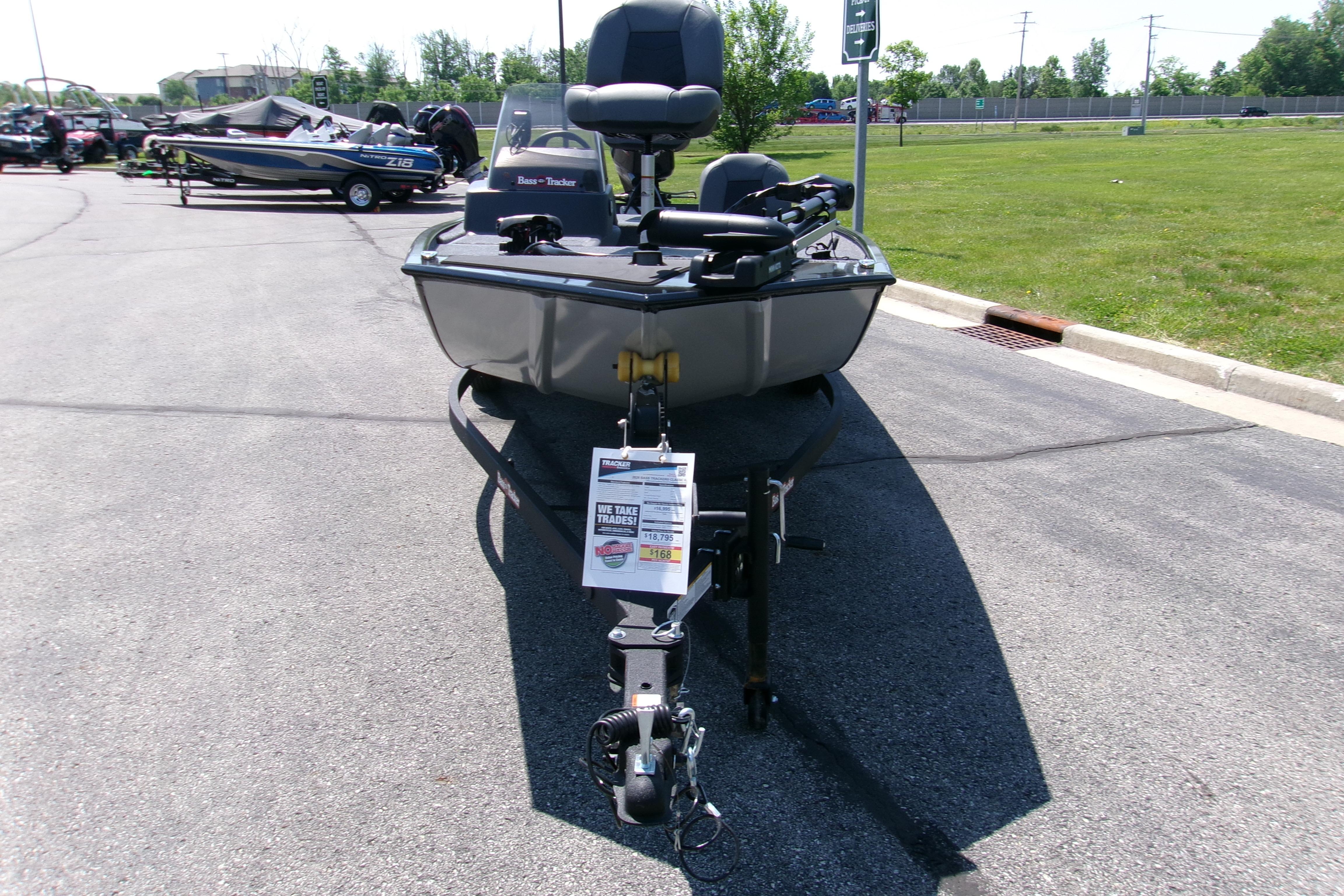 2026 Tracker Bass Tracker Classic XL boat on trailer in parking lot.
