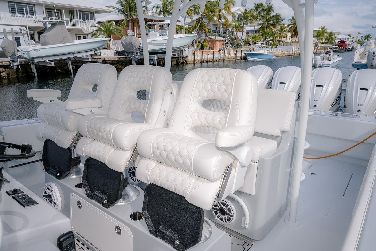 2024 Contender 44 ST boat interior with luxurious white seating and multiple outboard engines.