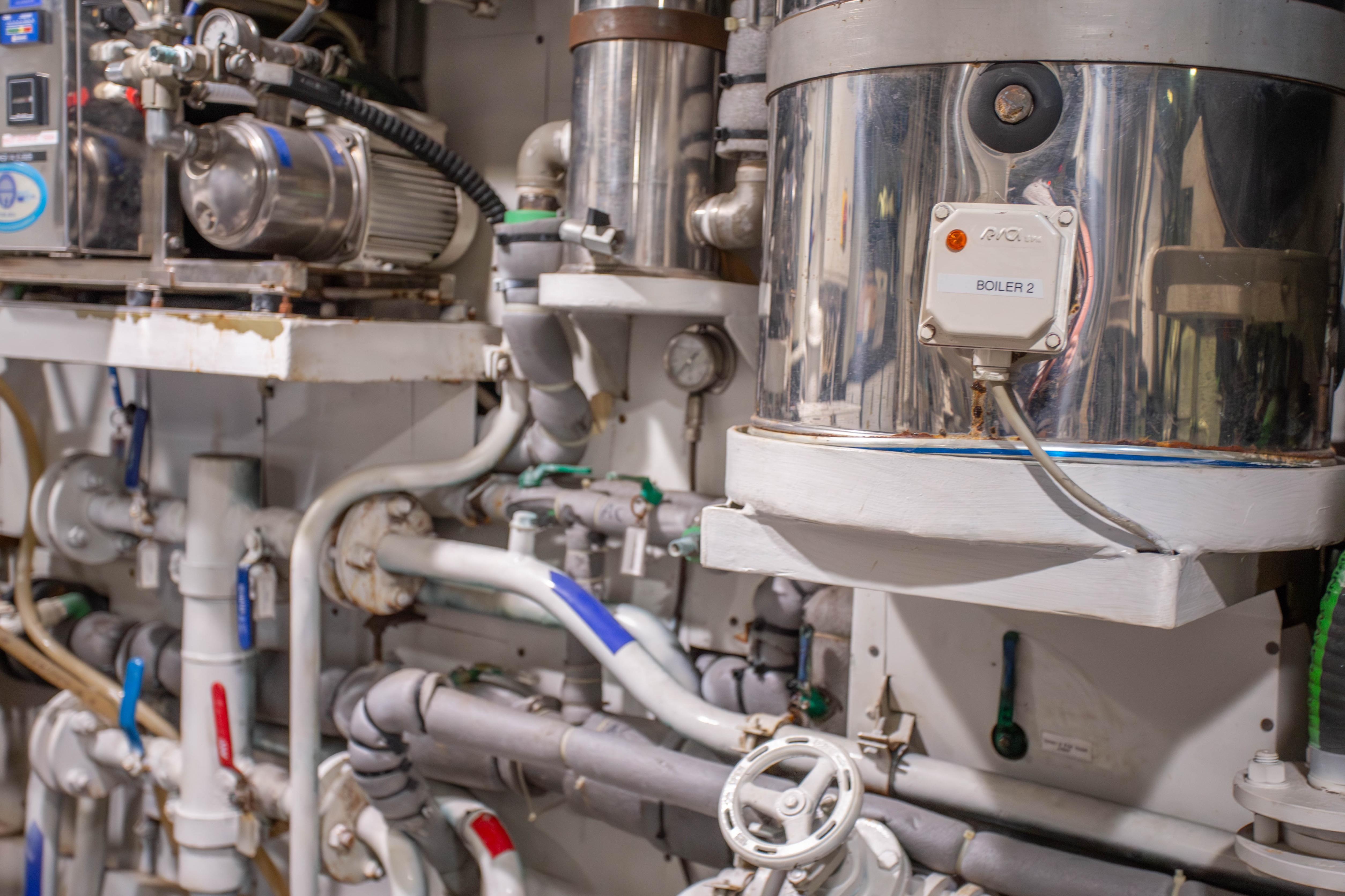 Engine room of 2014 Fifth Ocean Yachts 24m Displacement Explorer Yacht, featuring complex machinery.