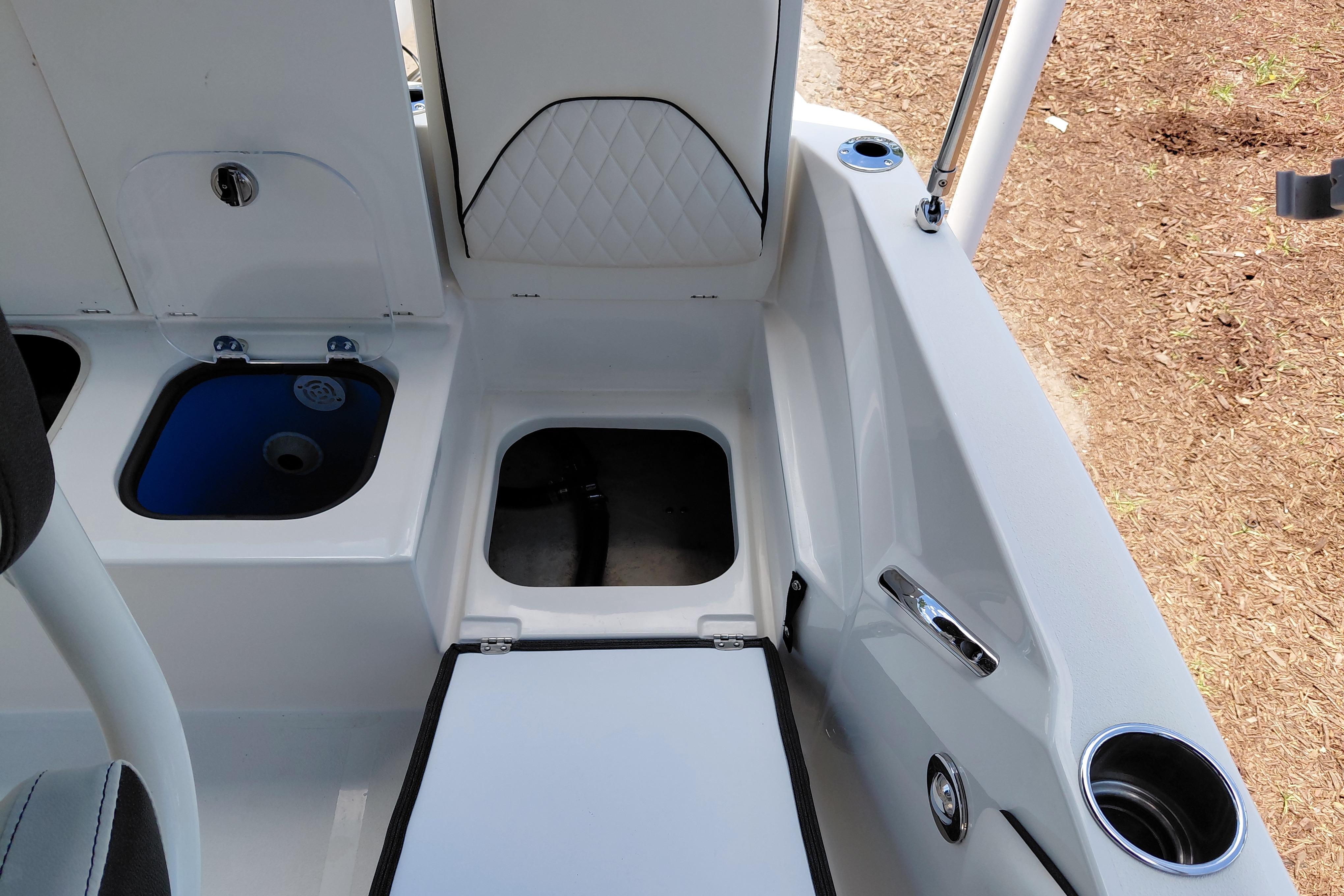 2023 Stingray 206 CC boat interior with storage compartments and cup holder.