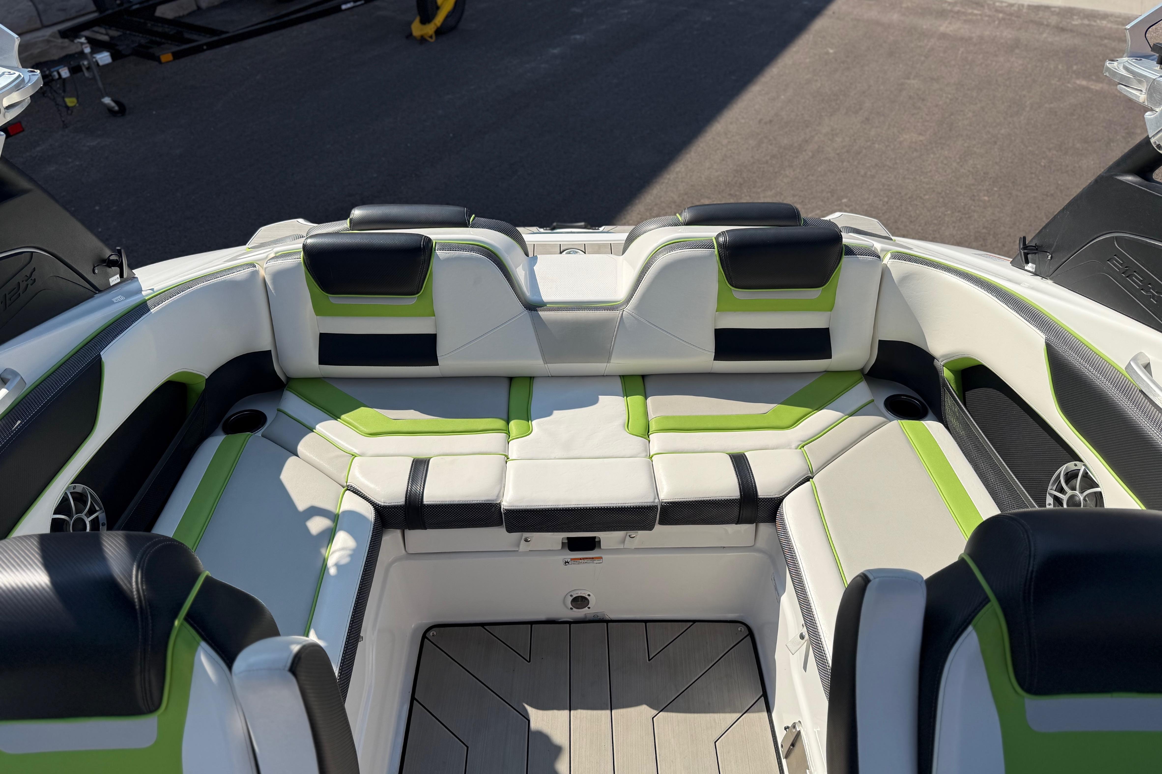 2022 Yamaha Boats 212XE interior with stylish green and black seating, showcasing modern design.